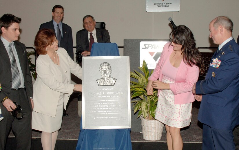 General Duncan J. McNabb, commander of Air Mobility Command, watches as Carmen Mikolajcik reveals the plaque honoring her husband, retired Brig. Gen. Thomas R. Mikolajcik during a formal ceremony for the new Mikolajcik Engineering Laboratory Center located on Naval Weapons Station Charleston March 16. Construction is expected to be completed in June 2007.  (U.S. Air Force Photo by Staff Sgt. Marie Cassetty)