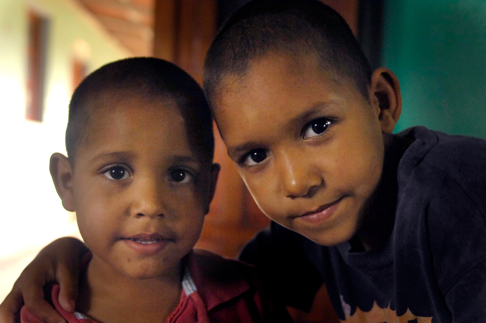 Two Nicaraguan boys living at the ABC Feed the Children Orphanage near San Taresa, Nicaragua, are preparing to enjoy food that Airmen brought for a birthday party March 17 at the orphanage.  The Airmen are participating in New Horizons-Nicaragua 2007, a $7.25 million joint U.S. and Nicaraguan military humanitarian and training exercise that will provide a new school and medical clinic, as well as free health and veterinary care, giving aid and strengthening bonds between the two nations. (U.S. Air Force photo/Staff Sgt. Jason T. Bailey)