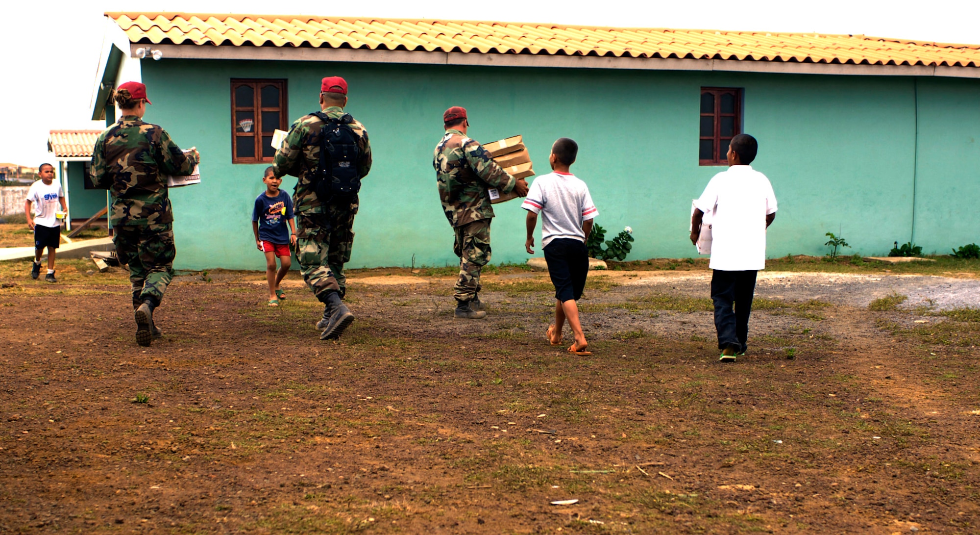 Staff Sgt. Holly Walters (from left), Capt. Carlos Diaz, and Staff Sgt. Adam Winter deliver food March 17 to the ABC Feed the Children Orphanage near San Taresa, Nicaragua.  The three Airmen are participating in New Horizons-Nicaragua 2007, a $7.25 million joint U.S. and Nicaraguan military humanitarian and training exercise that will provide a new school and medical clinic, as well as free health and veterinary care, giving aid and strengthening bonds between the two nations. (U.S. Air Force photo/Staff Sgt. Jason T. Bailey)