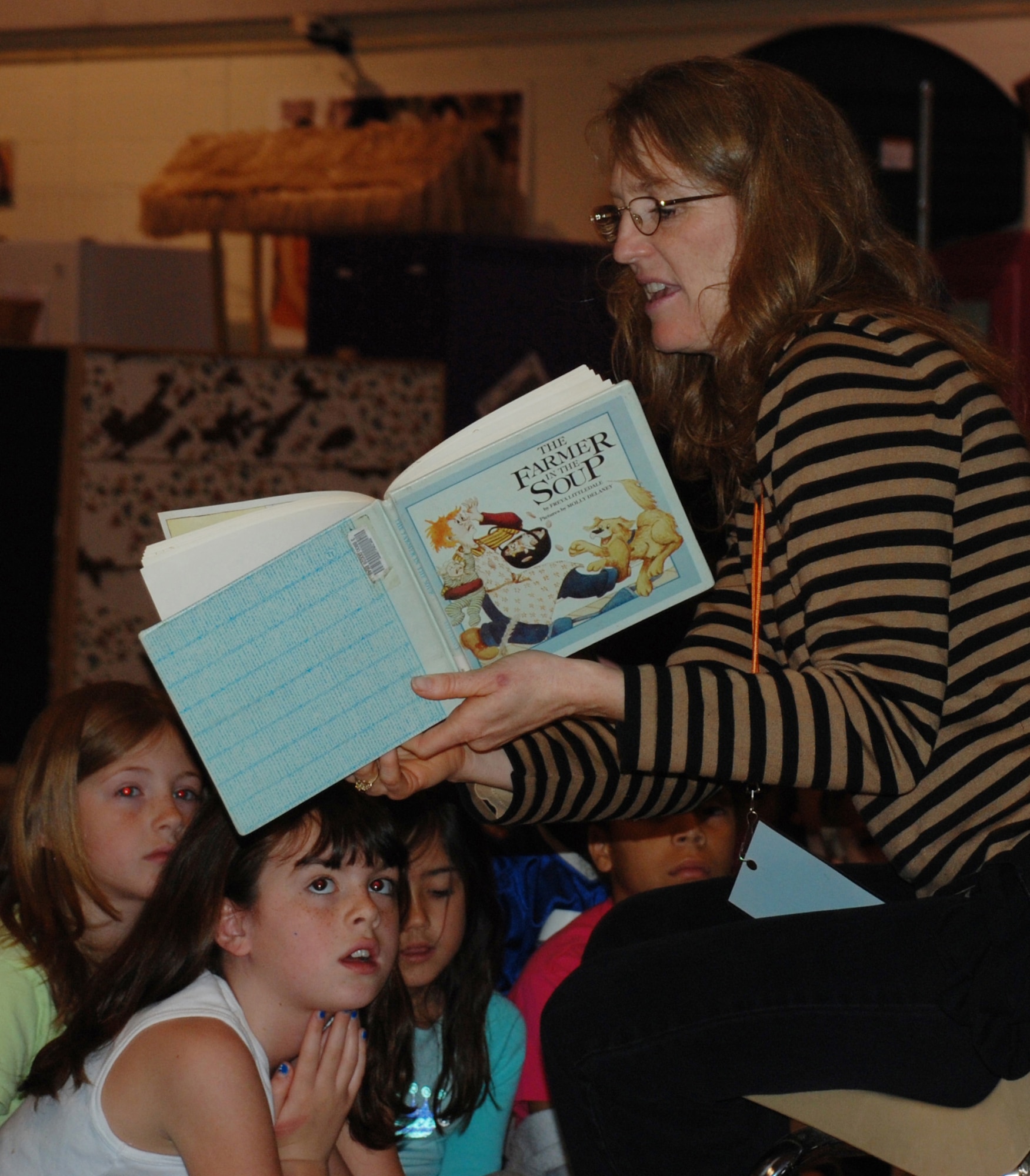 Pamela Conley, wife of 82nd Training Wing vice commander Col.  Lansen Conley, reads "The Farmer and the Soup" to children at the School-Age Program Center March 16. Mrs. Conley was reading to the children as part of women's history month story time. (U.S. Air Force photo/Adrian McCandless)