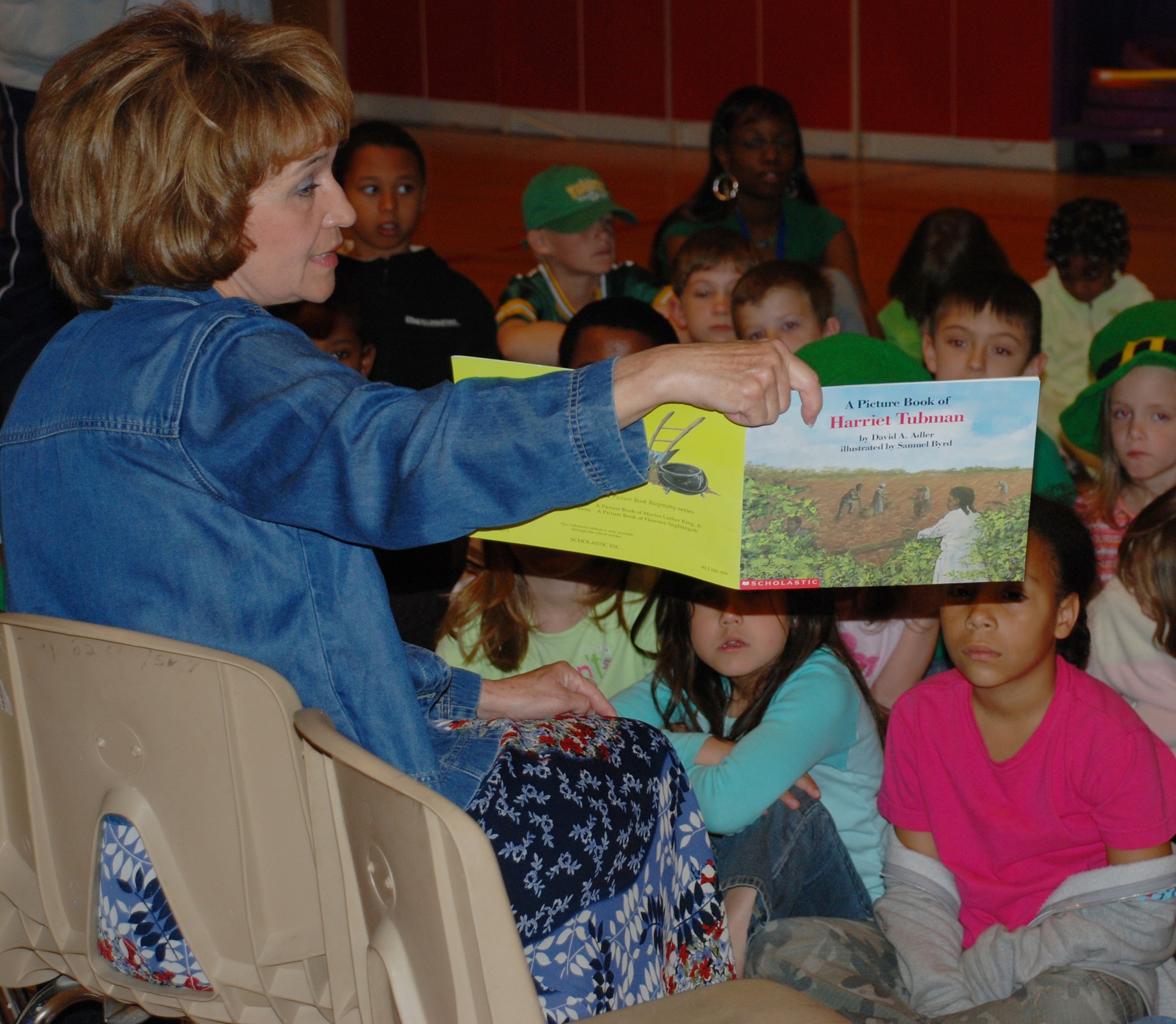 Elizabeth Devereaux, wife of Brig. Gen.  Richard Devereaux, commander of 82nd Training Wing, reads "A Picture Book of Harriet Tubman" March 16 to children at the School-Age Program Center. Mrs. Devereaux was reading to the children as part of women's history month story time. (U.S. Air Force photo/Adrian McCandless)