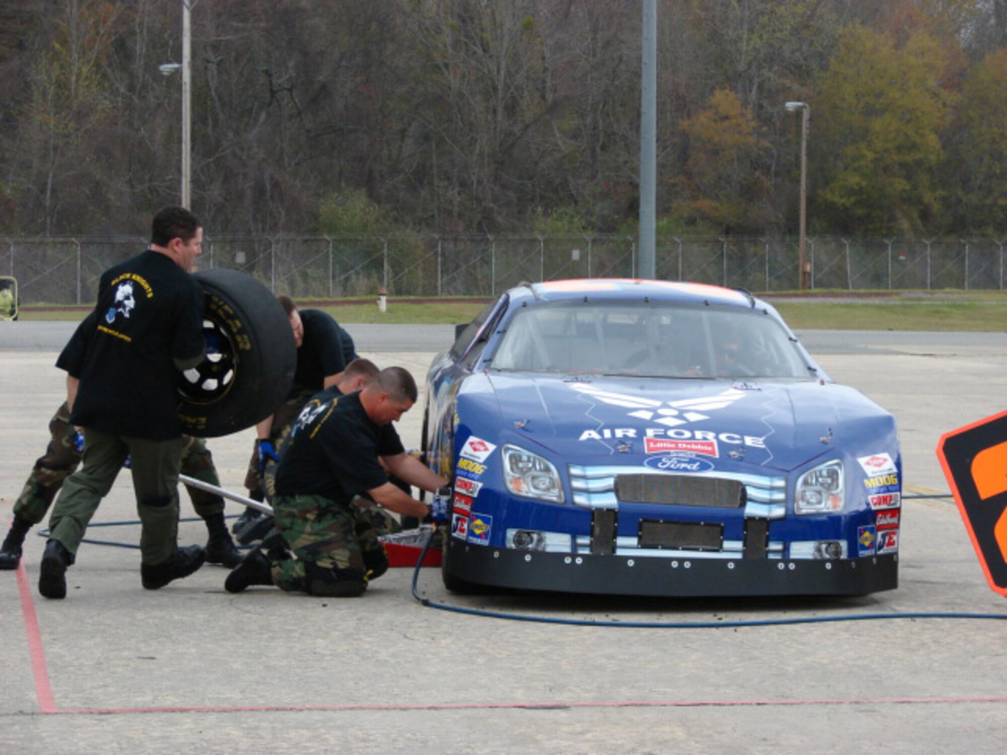 ROBINS AIR FORCE BASE, Ga. -- Airmen with the 19th Air Refueling Group junior varsity pit crew perform a winning tire change in 15.39 seconds, defeating their varsity counterparts to claim the championship during a NASCAR pit stop competition here March 15. (U.S. Air Force photo)