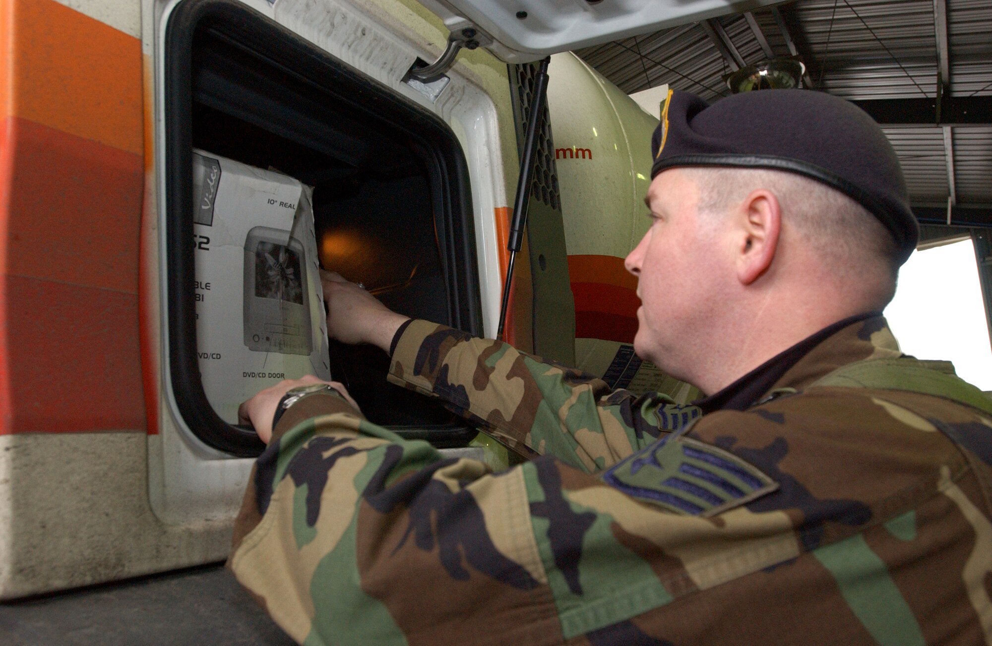Staff Sergeant Timothy Drake inspects one of the compartments on a lorry before clearing it for base entry at the search barn Feb. 16, 2007.  The search barn is the first line of defense in force protection.  Vehicles coming through are inspected for explosives, unauthorized persons, contraband and illegal weapons. (U.S. Air Force photo by Staff Sgt. Vanessa Bastidas)