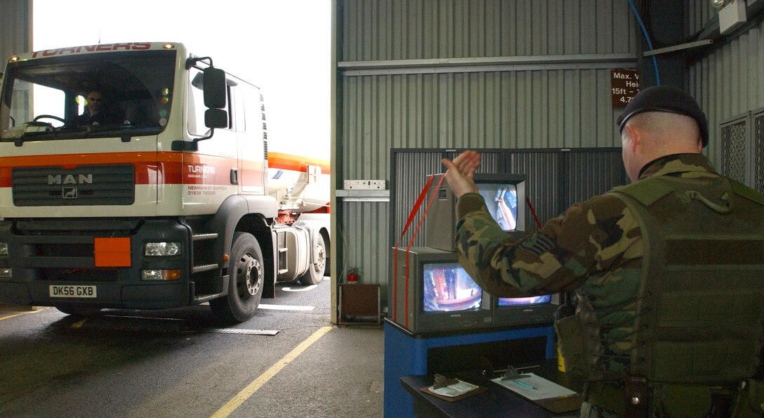 Staff Sergeant Timothy Drake, 100th Security Forces Squadron, directs a driver attempting to gain access to the base over the undercarriage camera at the search barn Feb. 16, 2007.  The search barn is the first line of defense in force protection.  Vehicles coming through are inspected for explosives, unauthorized persons, contraband and illegal weapons  (U.S. Air Force photo by Staff Sgt. Vanessa Bastidas)
