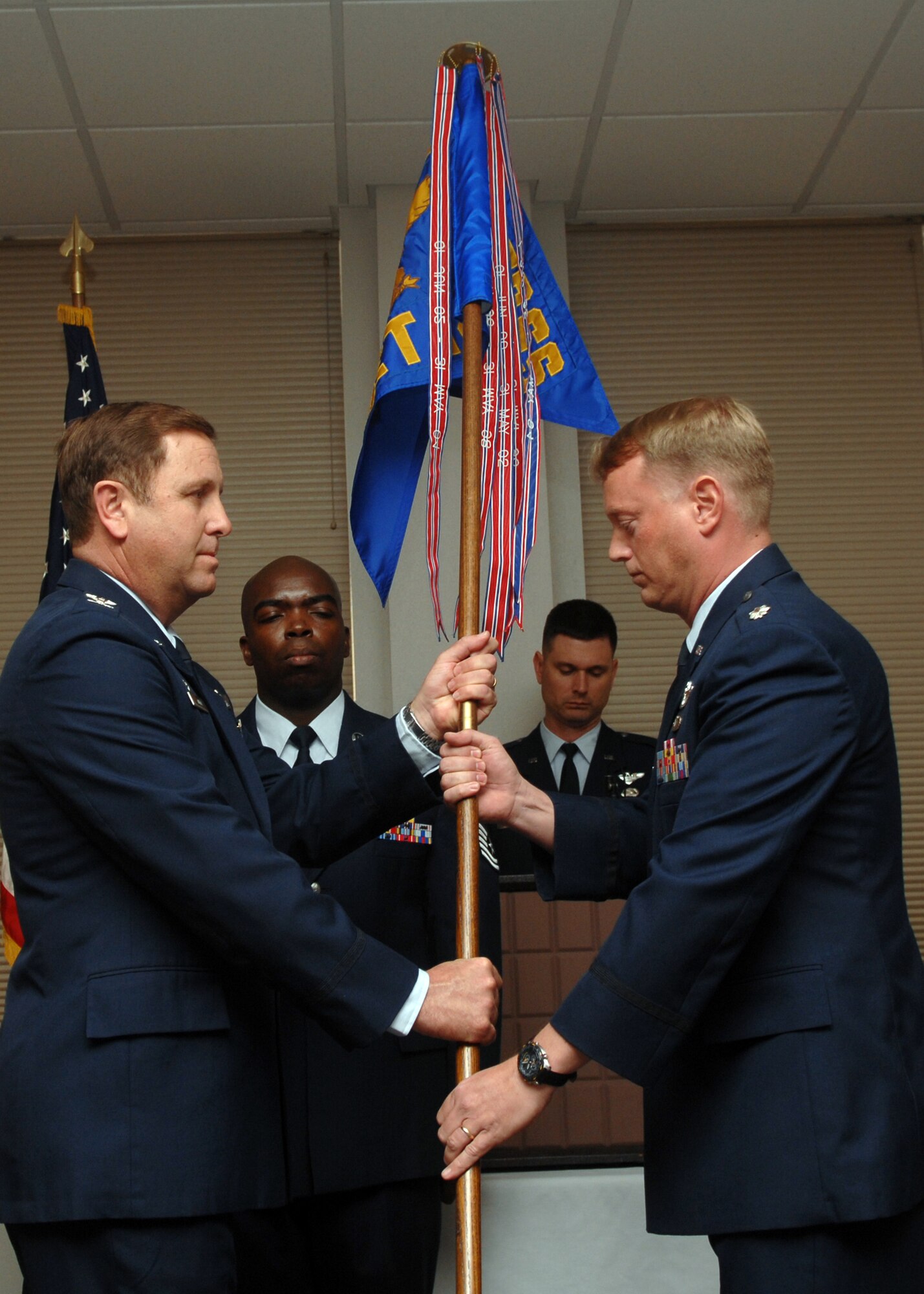 Lt. Col. Edward Presley assumes command of Detachment 14 of the ACC Training Support Squadron March 16. The passing of the guidon from outgoing commander to the officiating officer to the incoming commander marks the transfer of command of the unit.  Detachment 14, a training unit for B-1B aircrew members has been under the command of Lt. Col. Allen Wilson since March of 2004.