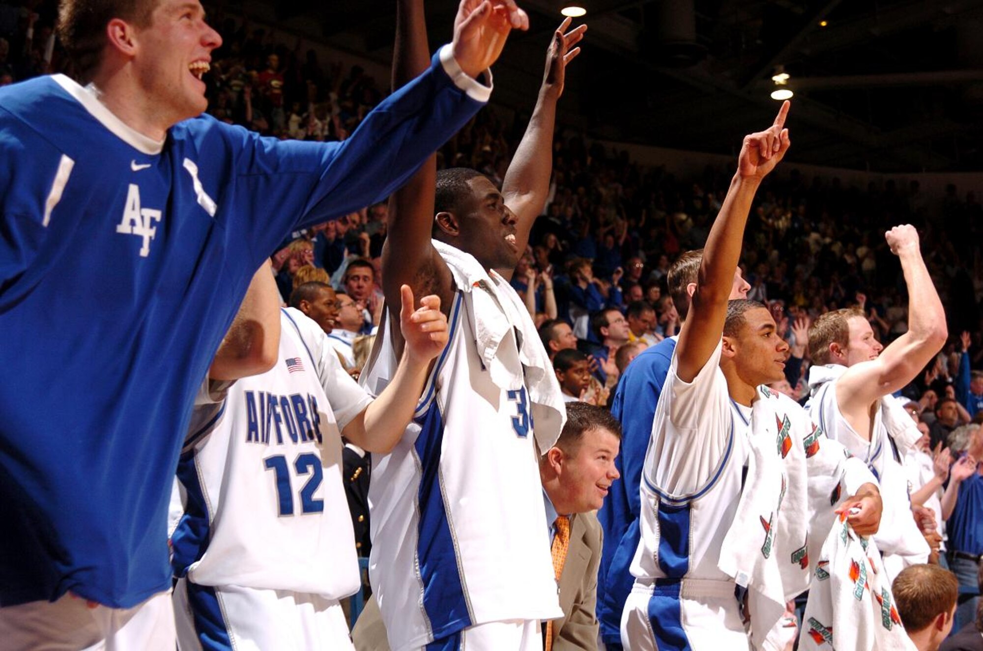 The Falcon starters stand up and cheer as their second string players increase their lead over Georgia late in their second round game of the National Invitation Tournament March 19 at the Air Force Academy's Clune Arena. Air Force went on to win, 83-52. The win over Georgia was Air Force's 25th of the season, a new school record. (U.S. Air Force photo/1st Lt. John Ross)
