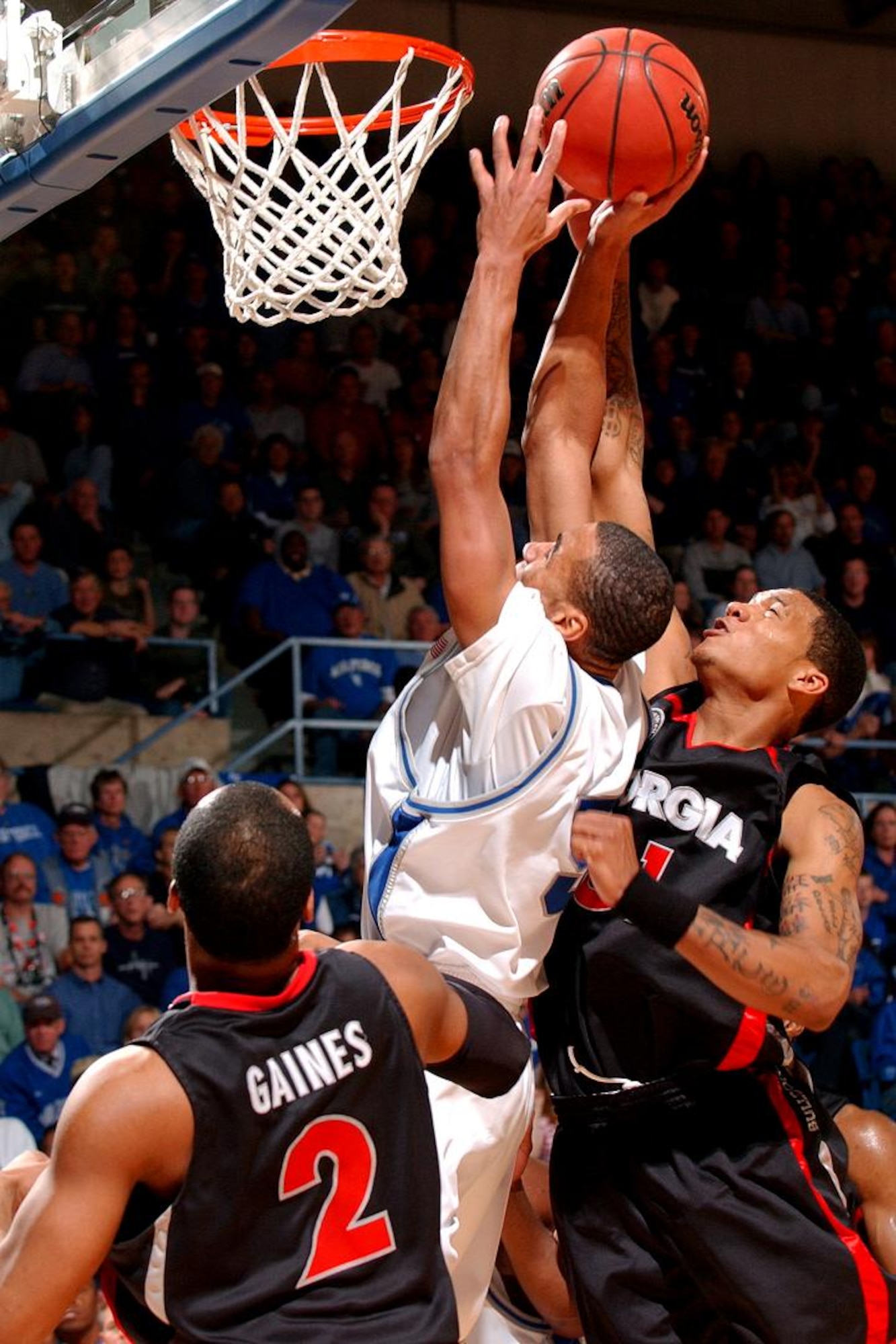 Air Force guard Matt McCraw is fouled by Georgia guard Billy Humphrey on his way to the basket March 19 in the second round of the National Invitation Tournament at the Air Force Academy's Clune Arena. With their 83-52 win over Georgia, Air Force set a school record for wins in a season at 25. (U.S. Air Force photo/Danny Meyer)                               