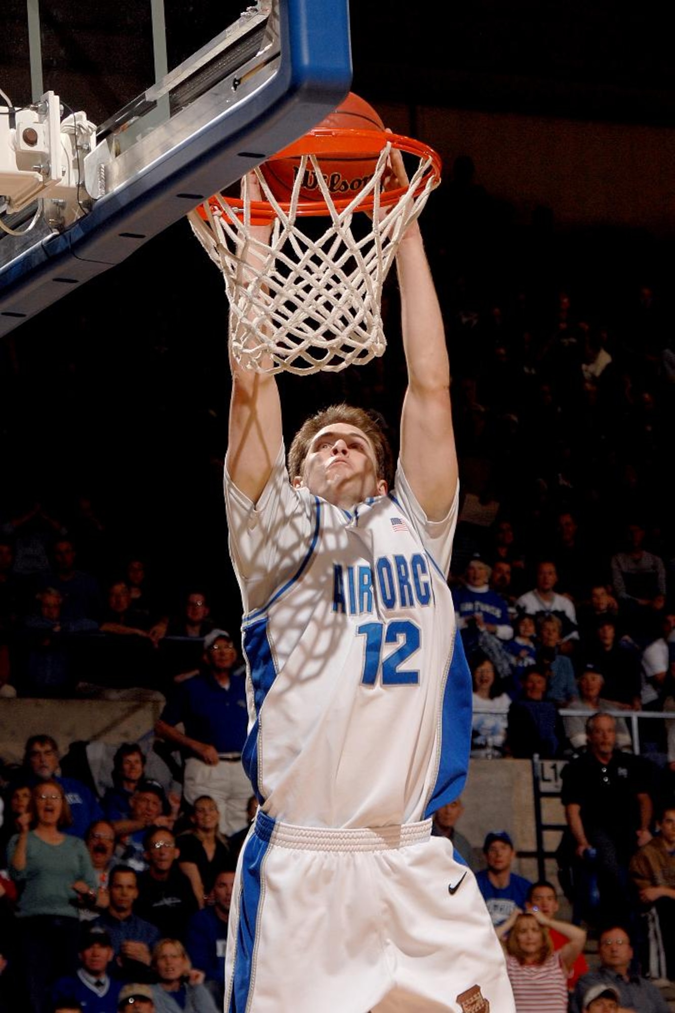 Air Force forward guard Tim Anderson brings the crowd at the academy's Clune Arena to its feet with a slam dunk March 19 in the second round of the National Invitation Tournament against Georgia. With their 83-52 win, Air Force set a school record for wins in a season at 25. (U.S. Air Force photo/Danny Meyer)