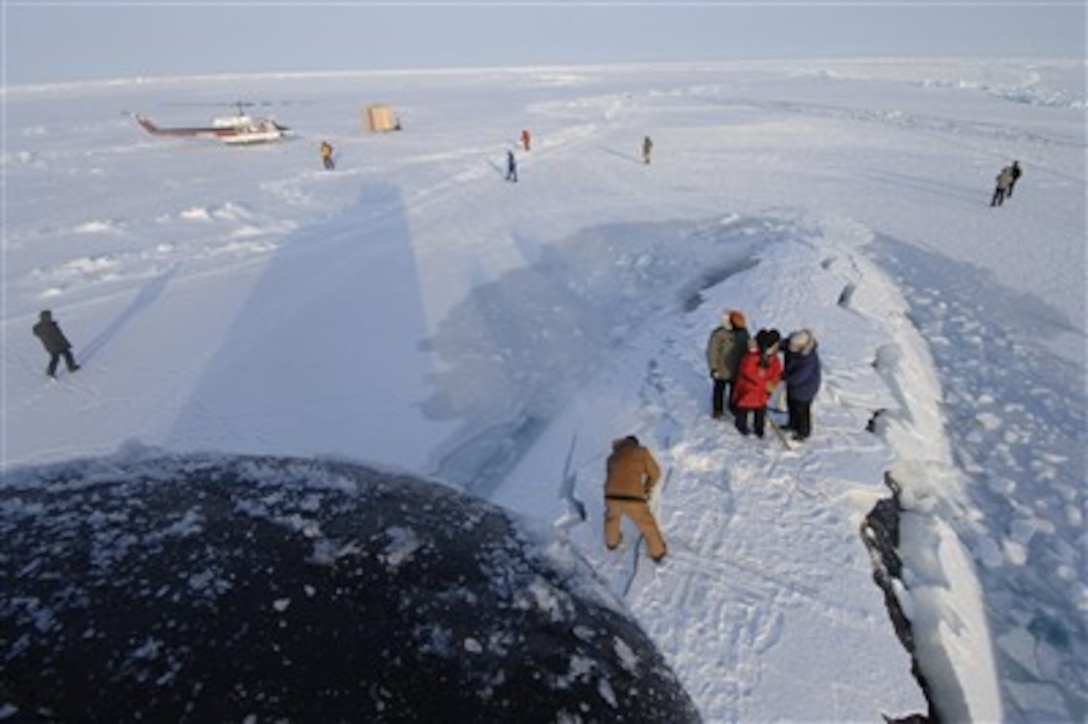 Sailors clear ice from the crew hatch aboard Los Angeles-class fast attack submarine USS Alexandria, March 18, 2007. Alexandria surfaced through three feet of ice during ICEX-07, a U.S. Navy and Royal Navy exercise conducted on and under a drifting ice floe about 180 nautical miles off the north coast of Alaska. 