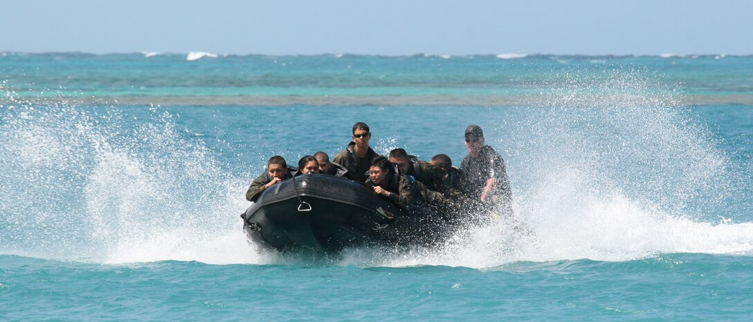 Cadets from Castle High School?s MCJROTC hold on tightly during a ride on a water boat, also known as a Zodiac, during day two of their spring camp. Other cadets practiced Marine Corps Martial Arts while waiting for their ride.