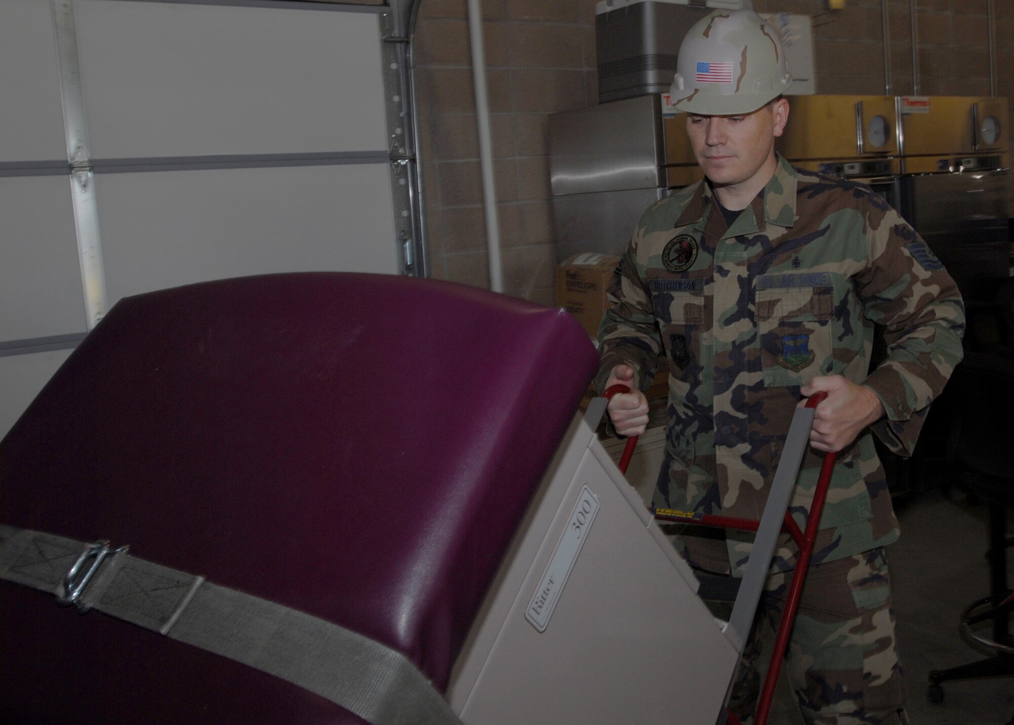 BUCKLEY AIR FORCE BASE, Colo. -- Tech. Sgt. Kevin Hutcherson, 460th Medical Group, moves a new bed from the new medical warehouse to be transported to the Buckley Clinic March 21. The newly designed warehouse cost about $725,000 and is a temperature-controlled storage facility that houses the 460th MDG homeland defense assemblages and war reserve materiel programs worth about $626,000. The medical logistics team mans the warehouse and is responsible for receiving, storing, inspecting and distributing medical supplies and equipment ranging from pharmaceutical drugs to non-medical equipment in order to enhance patient care. Medical supplies were stored in a variety of locations, including leased space, prior to the warehouse construction. (U.S. Air Force photo by Senior Airman Logan Tuttle)