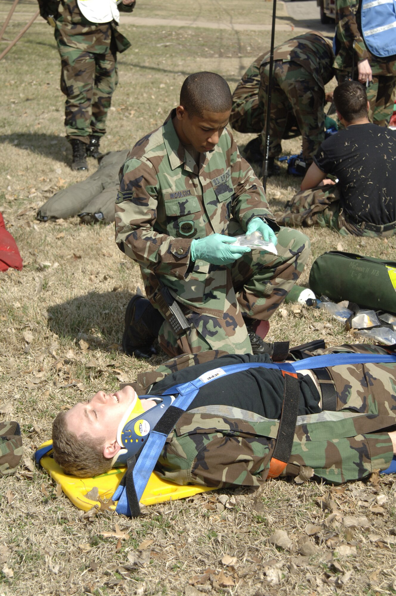 Airman 1st Class Marlon Woolcock, 22nd Medical Operations Squadron, prepares Capt. Shawn McGregor for an ambulance ride March 13 as part of a tornado response exercise at McConnell. During the exercise, McConnell's exercise evaluation team primarily assessed the effectiveness of the base's emergency notification systems. The EET also evaluated Team McConnell members' ability to shelter-in-place and each unit's capability to account for its members in an emergency situation. (Air Force photo by Airman 1st Class Roy Lynch)