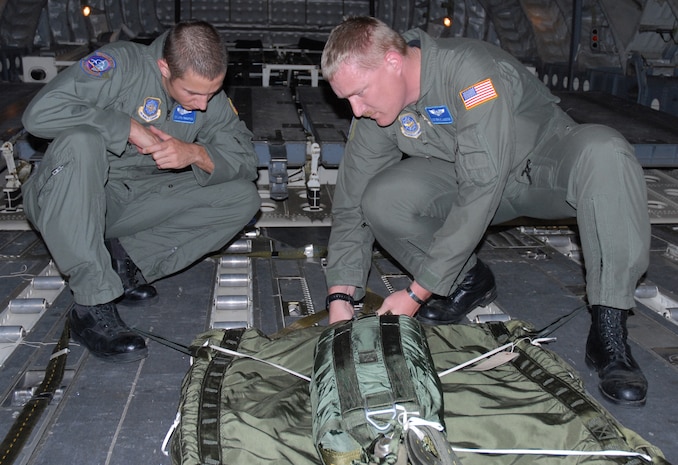 Staff Sgts. Justin Thompson, 437th Operations Support Squadron Combat Tactics Flight joint airdrop inspector, and Terry E. Langston, 437 OSS Combat Tactics Flight NCO in charge of JAI training, inspect the extraction package for an airdrop on the flightline Tuesday. (U.S. Air Force photo/Airman Melissa B. Harper)