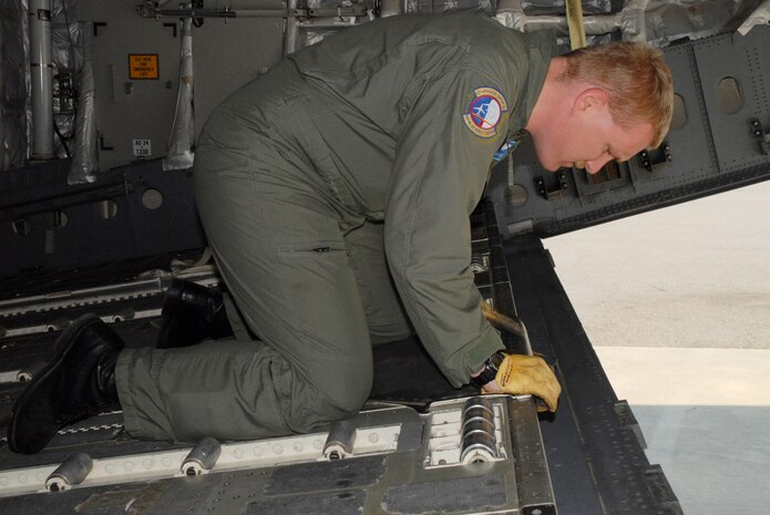Staff Sgt. Tery E. Langston, 437th Operations Support Squadron NCO in charge of JAI training, installs the Aerial Delivery System ramp hitch cover in praparation for an airdrop on the flightline Tuesday. (U.S. Air Force photo/Airman Melissa B. Harper)