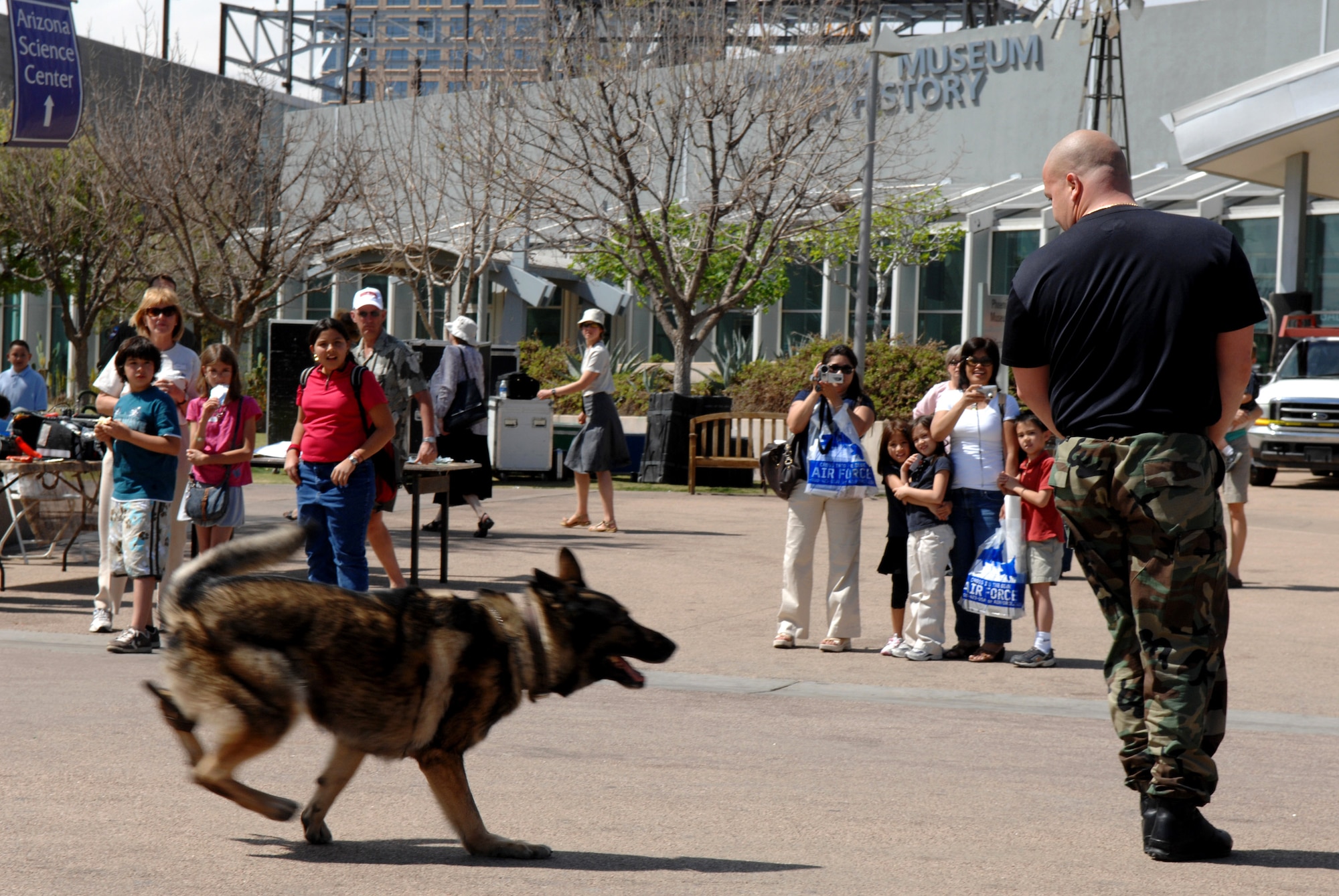 Cito, a security forces military working dog, pursues a "suspect" March 20 during a security forces demonstration at an Air Force Week event at the Arizona Science Center in downtown Phoenix. The demonstration showed the role of dogs and their handlers in the Air Force.  (U.S. Air Force photo/Staff Sgt. Brian Ferguson)
