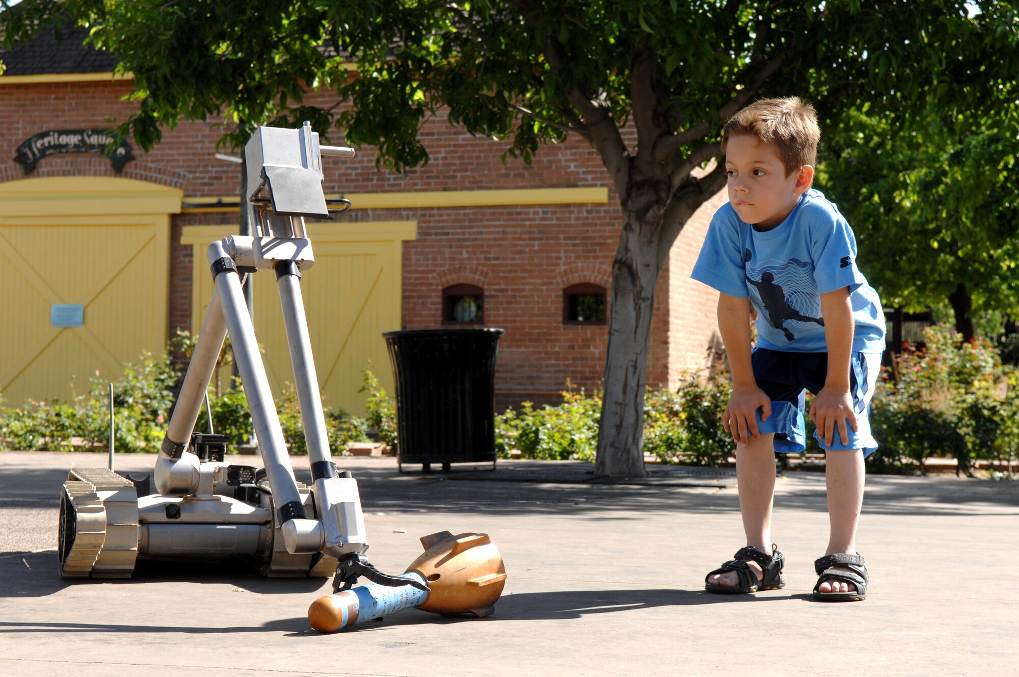 Antonia Ortiz, age 6, watches as an explosive ordnance disposal robot reaches down to retrieve a simulated bomb March 20. The display was part of Air Force Week at the Arizona Science Center in downtown Phoenix. (U.S. Air Force photo/Staff Sgt. Brian Ferguson)