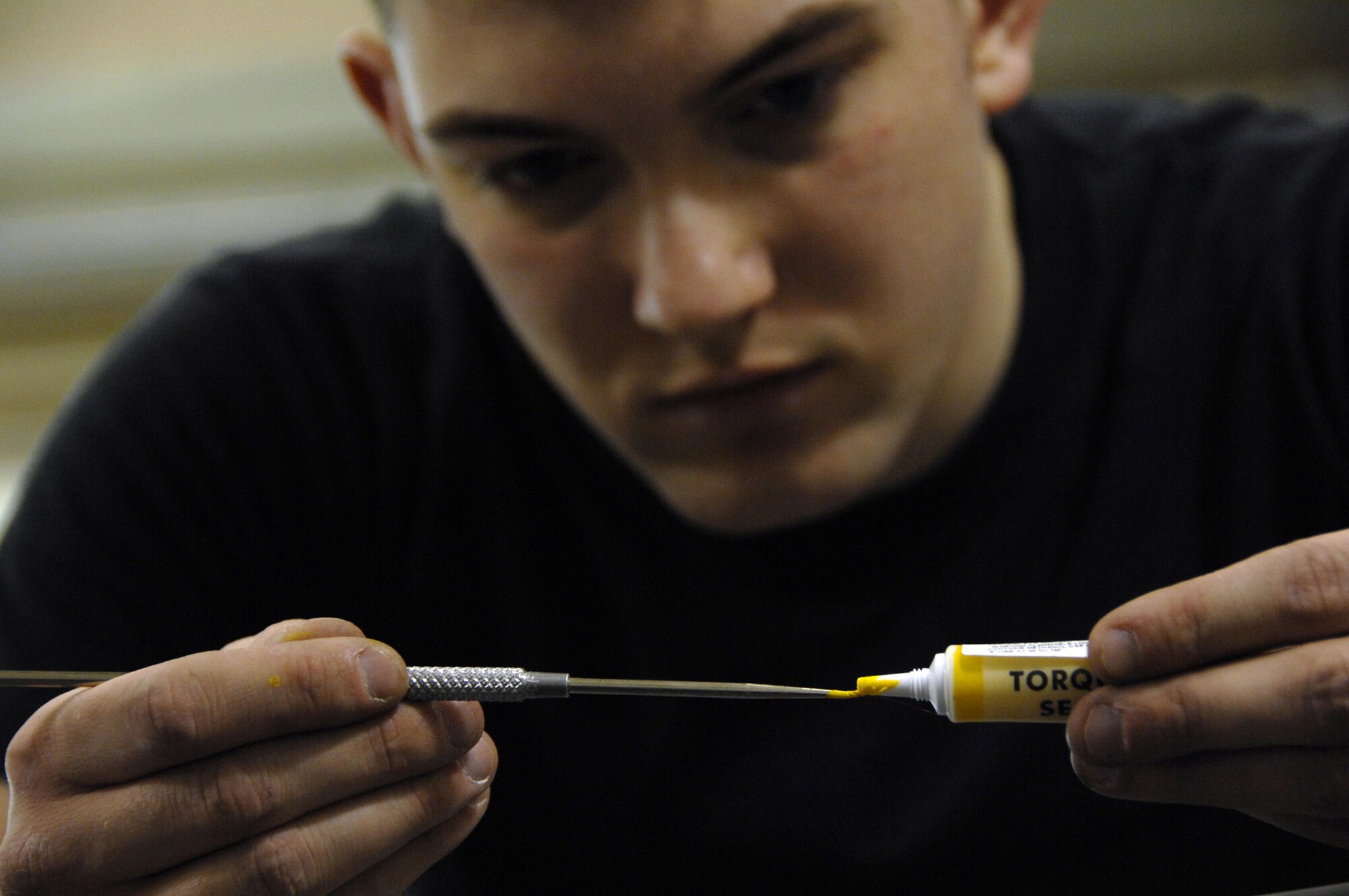 EIELSON AIR FORCE BASE, Alaska -- Airman 1st Class Stephen Rehdantz, 354th Maintenance Squadron, applies Torque Stripe to an application tool during an A-10 seat Time Compliance Technical Order 36 month seat inspection here on 21 Mar. The yellow stripe left after application serves as a visual notification that a part has come loose or un-torqued during normal seat usage.
(U.S. Air Force Photo by Staff Sgt Joshua Strang)