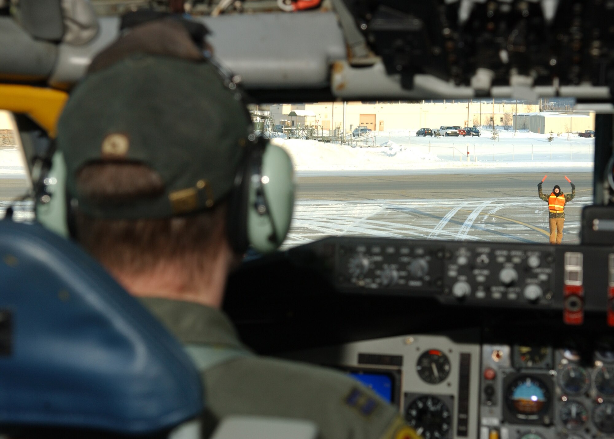 EIELSON AIR FORCE BASE, Alaska -- Capt. Ryan King, 168th Air Refueling Wing, Alaska Air National Guard, is being guided into place on the runway after returning from a refueling training mission. The 168th ARW mission is to train and equip KC-135R combat crews to provide air refueling in support of PACAF Operations Plans and worldwide refueling taskings.
 (U.S. Air Force photo by Airman 1st Class Jonathan Snyder)