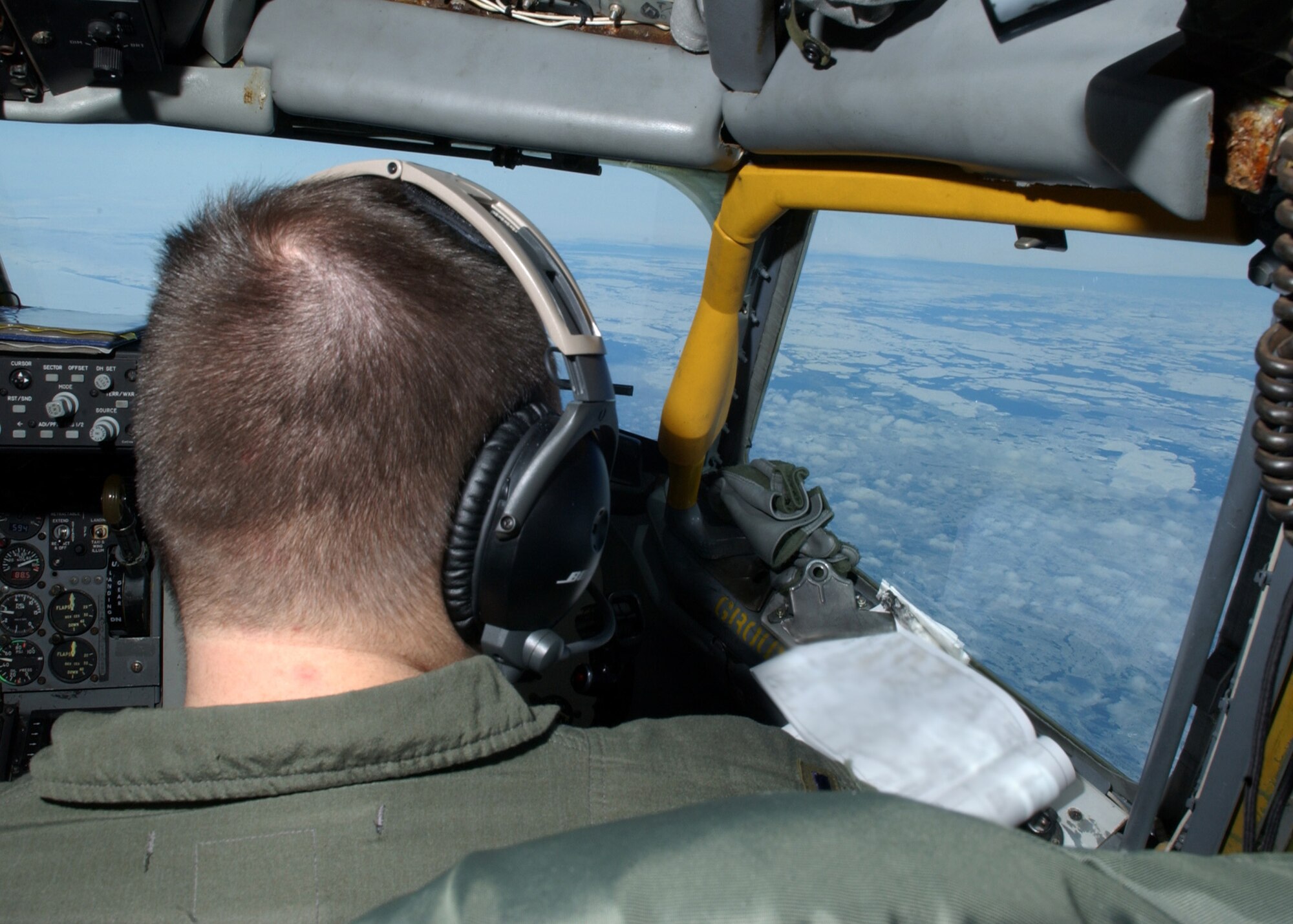 EIELSON AIR FORCE BASE, Alaska -- 1st Lt. Steve Akins, 168th Air Refueling Wing, Alaska Air National Guard, looks outside at the Bering Sea returning from a refueling training mission. The 168th ARW mission is to train and equip KC-135R combat crews to provide air refueling in support of PACAF Operations Plans and worldwide refueling taskings.
 (U.S. Air Force photo by Airman 1st Class Jonathan Snyder)