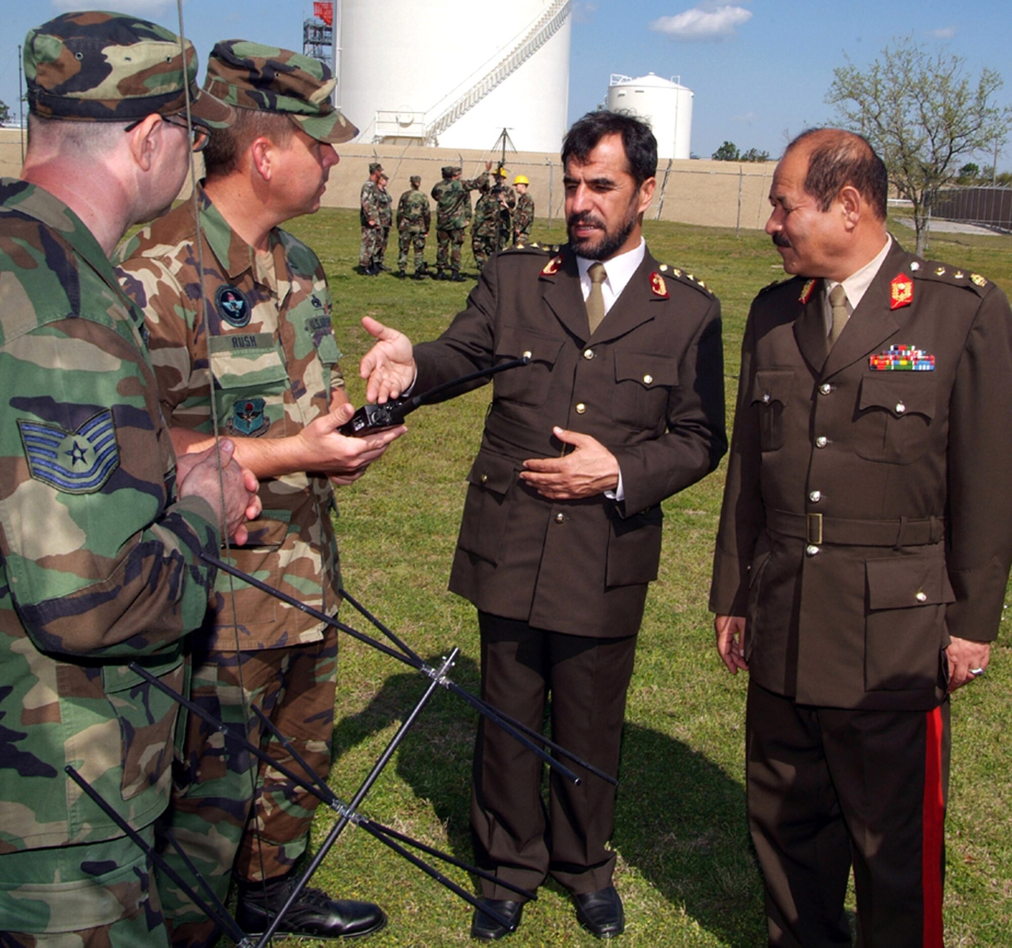 Technical Sgt. Joseph Carello and Master Sgt. Edward Rush talk to Col. Said Farooq Yosuf Zai and Maj. Gen. Mehrab Ali about a multi-band interteam radio March 16 at Keesler Air Force Base, Miss. The officers are members of the Afghan National Army. Sergeants Carello and Rush are instructors with the 338th Training Squadron here. (U.S. Air Force photo)