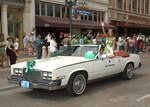 Commander of the 59th Medical Wing, Brig. Gen. David Young III, and his wife, Martha, escort Miss Bexar County 2007, Alexandra Peais, in the Youngs' 1985 Cadillac during the parade March 17. The theme of the 39th annual St. Patrick's Day Parade was "The Green Honors the Blue." The parade had a blend of participants from civic, social, business, educational, patriotic and military organizations. (USAF photo by Alan Boedeker)                                