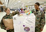 Making a difference in someone else's life, Staff Sgt. Monique Cahill, left, and Master Sgt. Bianca Pulley leave items in one of seven collection boxes on base. The Women's History Month Committee will continue collecting donations for the Battered Women and Children's Shelter of Bexar County through March 30. Requested donations include baby items, women's toiletries, laundry products and cleaning supplies. Collection boxes are located at the Lackland Child Development Center, the commissary, Wilford Hall Medical Center, 37th Training Wing, 37th Mission Support Group, 37th Training Group and the 737th Training Group. Donations are scheduled to be delivered to the shelter March 31. The shelter provides emergency shelter or transitional housing, education and effective parenting training, and early intervention with children. More information about the shelter is available at www.fvps.org. Sergeant Cahill is assigned to the 59th Training Squadron. Sergeant Pulley is with the 59th Medical Training Group. (USAF photo by Robbin Cresswell)