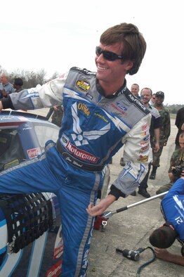 Jon Wood, driver, climbs out of the #21 Air Force car,Thursday March 15 during the pit crew competition. U. S. Air Force photo by Sue Sapp 