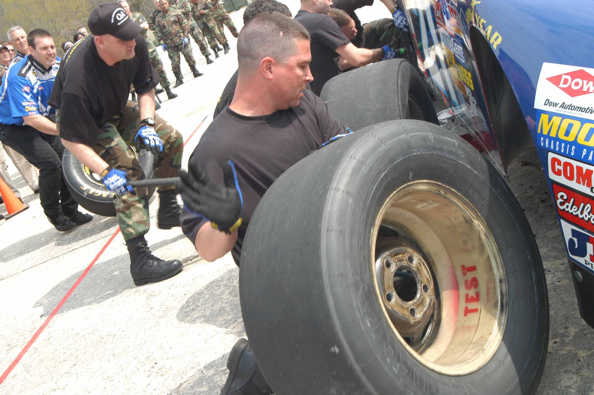 TSgt. Barry Stone, 19th JV team, lifts the right front tire out of the way so it can be replaced. The 19th JV team won the competition. U. S. Air Force photo by Sue Sapp    