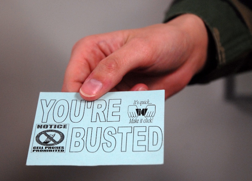 The 437th Airlift Wing Safety Office will be handing out "You're Busted" cards to Arimen found not wearing a seat belt or while driving while talking on a cell phone without a hands-free device. (U.S. Air Force photo/Senior Airman Sam Hymas)