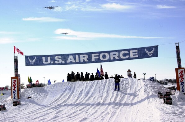 As part of the Air Force 60th Anniversary commemoration, two 934th Airlift Wing C-130s perform a flyover at the Air Force Canterbury Park Snocross races in Shakopee, Minn. The opening ceremony showcased a group Air Force enlistment conducted by Brig. Gen. Greg Feest, Deputy Director of Force Application, the Pentagon, 
