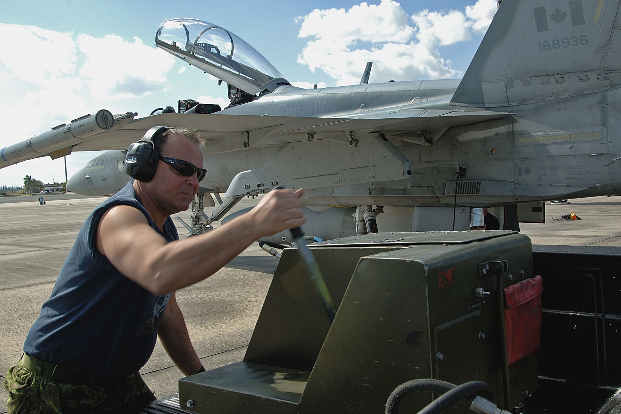 Corporal (Cpl) Sandy Schnurr, an avionics technician from Lethbridge, Alberta, pumps hydraulic fluid into a Canadian Forces CF-18 Feb. 22 at Homestead Air Reserve Base, Fla. The three-week Dissimilar Aircraft Combat Training exercise tested the air-to-air combat skills of both Canadian and American fighter pilots. (Canadian Air Force photo/Cpl. J.A. Wilson)