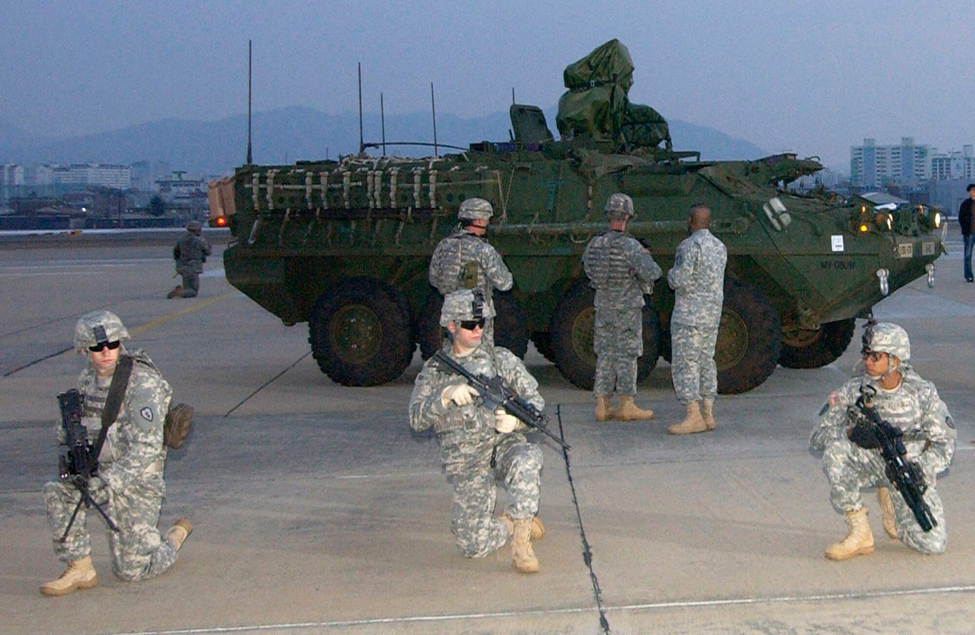 Soldiers from the 27th Infantry Division provide security for an M1126 Stryker infantry carrier vehicle that had just been offloaded from a C-17 Globemaster III March 18 in Daegu, South Korea, for Exercise Foal Eagle 2007.  The focus of the exercise is on strategic, operational and tactical aspects of general military operations in the Korean theater of operations.  Its intent is to demonstrate resolve to support the Republic of Korea against external aggression while improving ROK - U.S. combat readiness and joint and combined interoperability. The C-17 is from the 15th Airlift Wing at Hickam Air Force Base, Hawaii. (U.S. Air Force photo/Master Sgt. Richard Freeland)