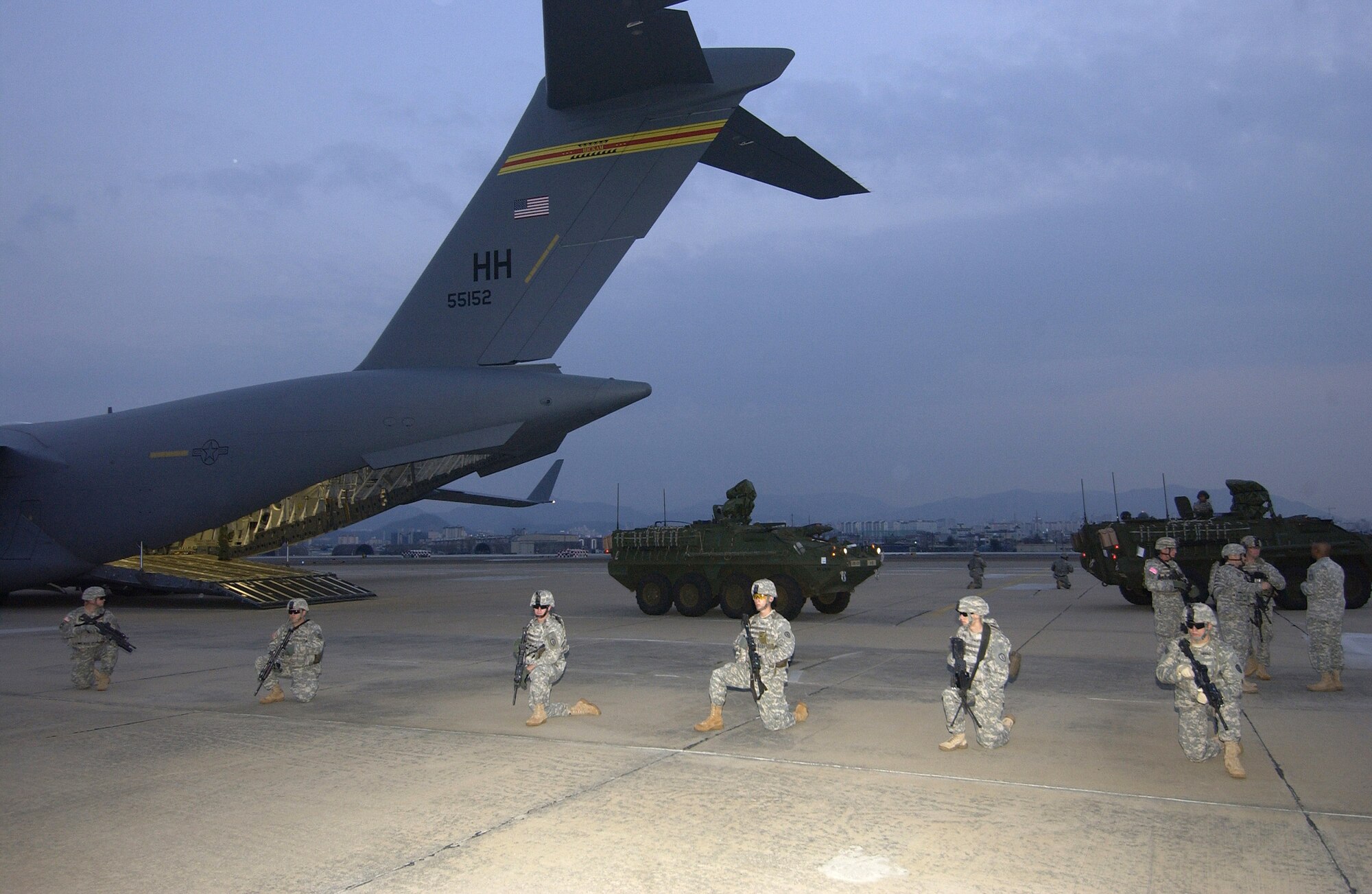 Soldiers from the 27th Infantry Division provide security as two M1126 Stryker infantry carrier vehicles are offloaded from a C-17 Globemaster III March 18 in Daegu, South Korea, for Exercise Foal Eagle 2007.  The focus of the exercise is on strategic, operational and tactical aspects of general military operations in the Korean theater of operations.  Its intent is to demonstrate resolve to support the Republic of Korea against external aggression while improving ROK - U.S. combat readiness and joint and combined interoperability. The C-17 is from the 15th Airlift Wing at Hickam Air Force Base, Hawaii. (U.S. Air Force photo/Master Sgt. Richard Freeland)