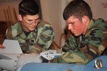 MINOT AIR FORCE BASE, N.D. -- Senior Airmen Jerry Isaacson (left) and Eric Haynes, both from the 5th Munitions Squadron, build a precision guided munition during a Logistics Standardization Evaluation Team visit here March 20. The LSET evaluates and ensures key logistics processes are standardized, repeatable and technically compliant. (U.S. Air Force photo by Airman 1st Class Sharida Bishop)
