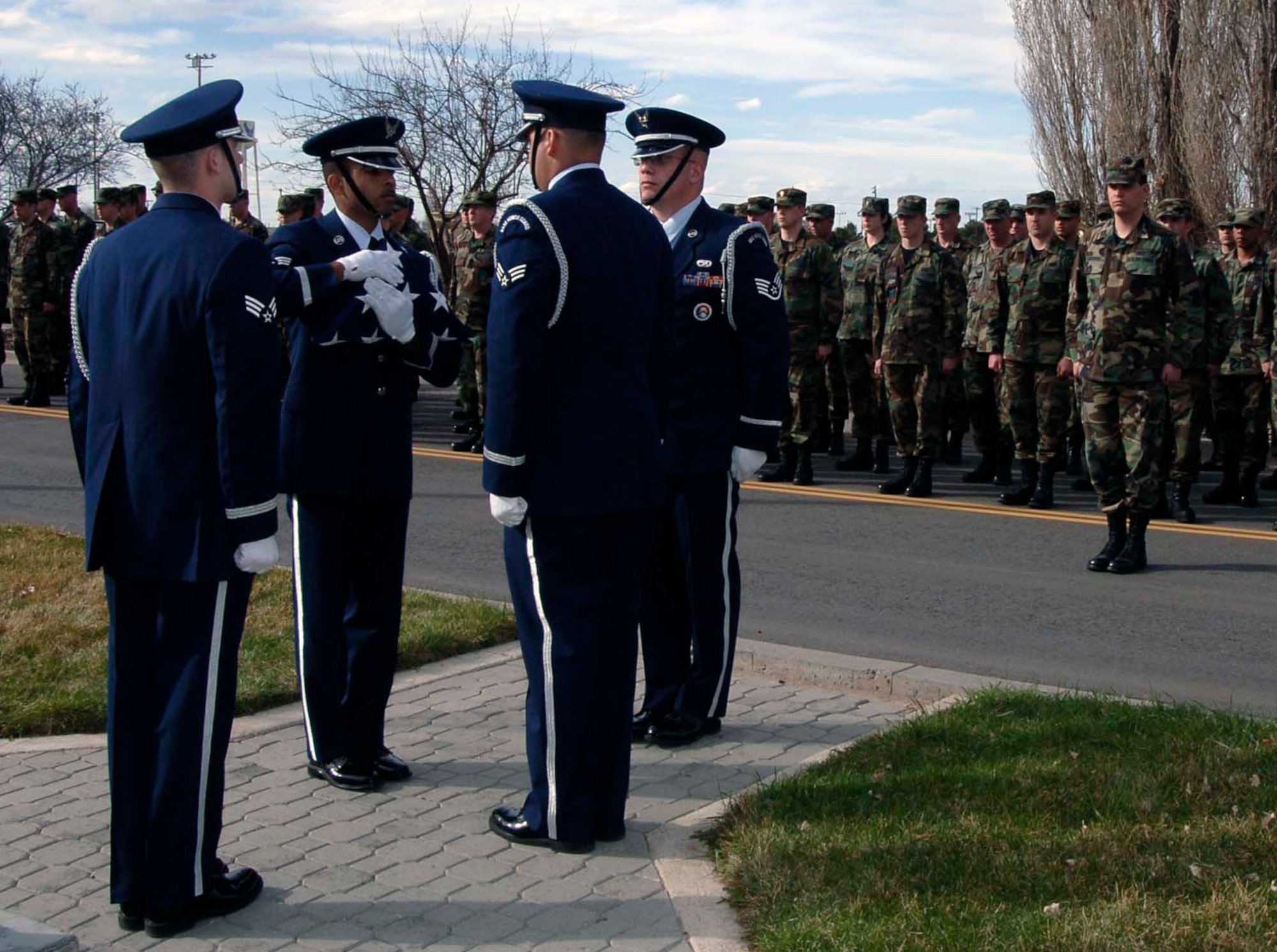 MOUNTAIN HOME AIR FORCE BASE, Idaho -- The base honor guard team prepares to give the flag a final salute before securing it for the night during a retreat ceremony here March 19. Members from the 366th Mission Support Group paid their respects to the colors during the ceremony. Air Force photo by Airman 1st Class Stephany Miller