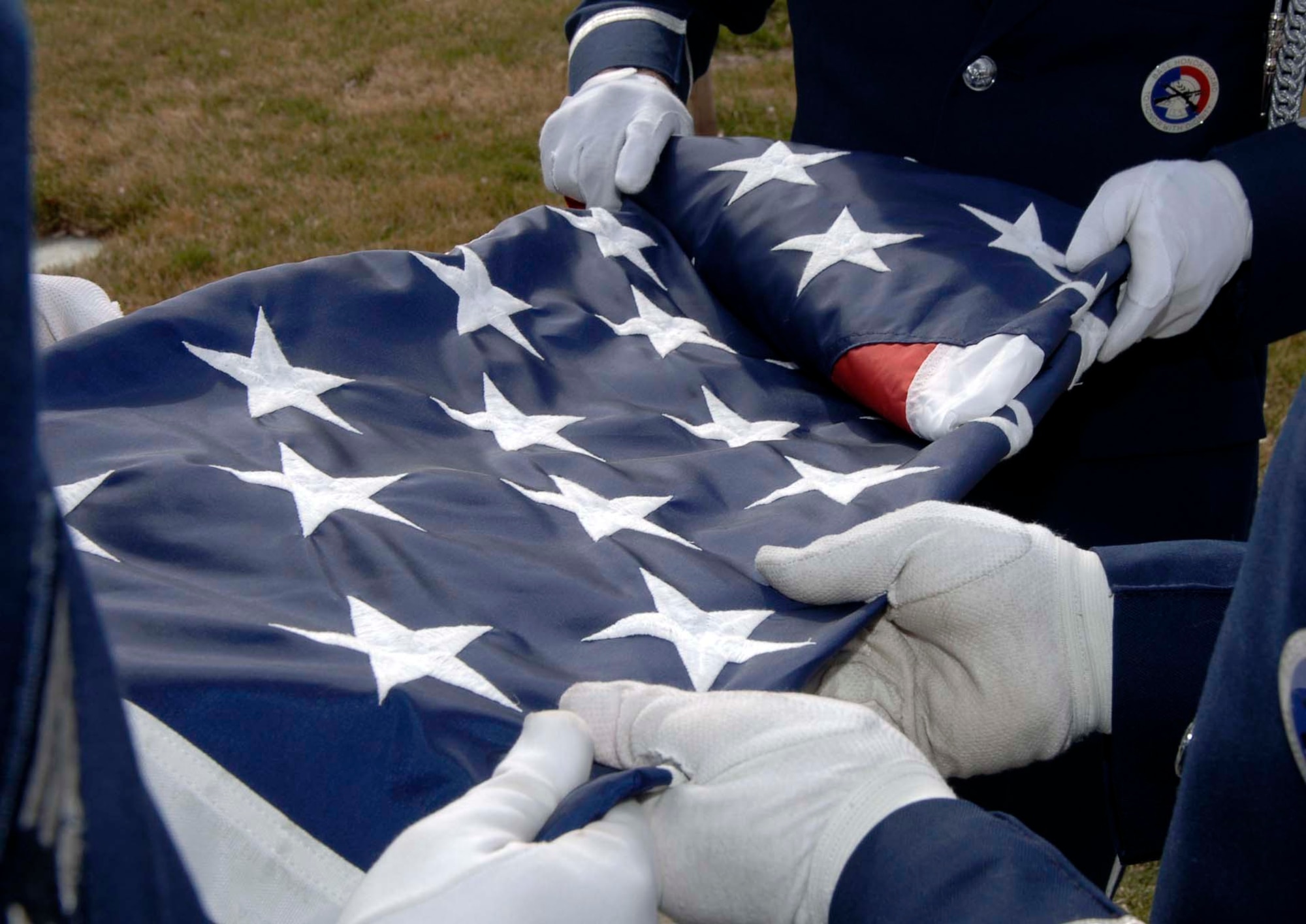 MOUNTAIN HOME AIR FORCE BASE, Idaho -- The base honor guard folds the colors during a formal retreat ceremony here March 19. Members of the 366th Mission Support Group stood in formation to start of the year's monthly formal retreat ceremonies. The ceremony reminds Airmen at places like Mountain Home to take time each day to respect the colors, remember those who served and support those currently deployed. Air Force photo by Airman 1st Class Stephany Miller