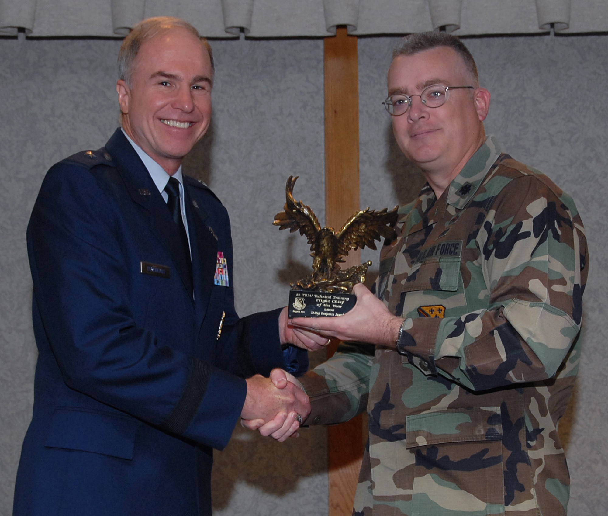 Lt. Col. Russell Tutty, commander of the 372nd Training Squadron, accepts the 82nd Training Wing Flight Chief of the Year award March 19 from 82nd TRW Commander Brig. Gen. Richard Devereaux on behalf of Senior Master Sgt. Benjamin Saunders.  Sergeant Saunders coordinated the beddown of the 435th Munitions Squadron at Ramstein Air Base, Germany, coordinated the acquisition of the first ever F-117 training aircraft and coached spring and fall Little League baseball for local youth. (U.S. Air Force photo/Mike Litteken)