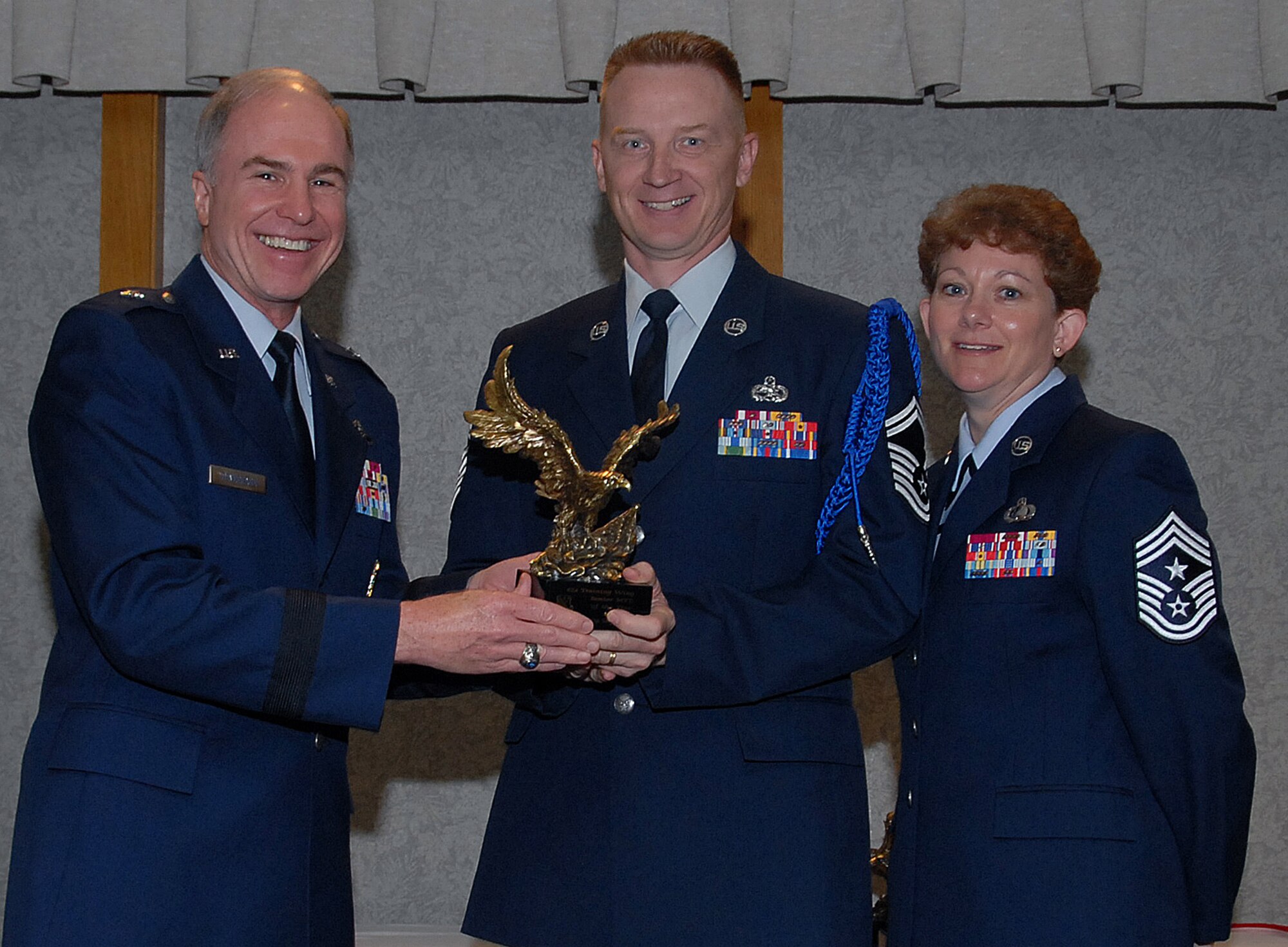 Senior Master Sgt. Terry Neuharth of the 82nd Training Wing accepts the 82nd TRW Senior Military Training Leader of the Year award March 19 from 82nd TRW Commander Brig. Gen. Richard Devereaux and 82nd TRW Command Chief Chief Master Sgt. Jeannie McLean.  Sergeant Neuharth trained and supervised 16 wing parades, drove key points on the phase program at the 2nd Air Force Phase summit and was a member of the 2nd AF Annual Awards Banquet. (U.S. Air Force photo/Mike Litteken.)