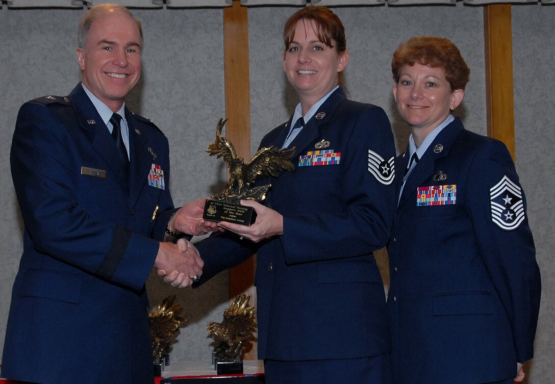 Tech. Sgt. Jacquilynn Astorga of the 782nd Training Group accepts the 82nd Training Wing award for Support Non-commissioned Officer of the Year March 19 from 82nd TRW Commander Brig. Gen. Richard Devereaux and 82nd TRW Command Chief Chief Master Sgt. Jeannie McLean.  Sergeant Astorga brought the squadron online with the Integrated Maintenance Data system to track ancillary training, which cut overdue training to 2 percent quarterly. She also created a training web page that eased accessibility and reduced training research time for 1,029 people and was a team captain for the 2006 American Cancer Society Relay for Life. (U.S. Air Force photo/Mike Litteken)