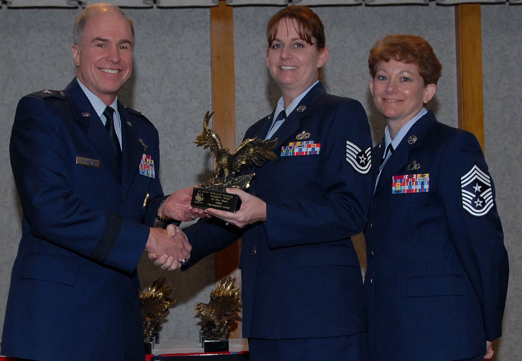 Tech. Sgt. Jacquilynn Astorga of the 782nd Training Group accepts the 82nd Training Wing award for Support Non-commissioned Officer of the Year March 19 from 82nd TRW Commander Brig. Gen. Richard Devereaux and 82nd TRW Command Chief Chief Master Sgt. Jeannie McLean.  Sergeant Astorga brought the squadron online with the Integrated Maintenance Data system to track ancillary training, which cut overdue training to 2 percent quarterly. She also created a training web page that eased accessibility and reduced training research time for 1,029 people and was a team captain for the 2006 American Cancer Society Relay for Life. (U.S. Air Force photo/Mike Litteken)