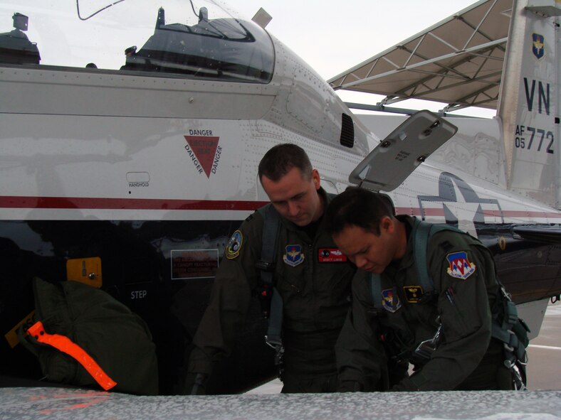 VANCE AIR FORCE BASE, Okla. -- Capt. Scott Linck, 8th Flying Training Squadron "O" Flight commander, and Capt. Jared Sproat, 8th FTS student pilot, review pre-flight checklist prior takeoff March 20. (U.S. Air Force photo/Jennifer Carroll)