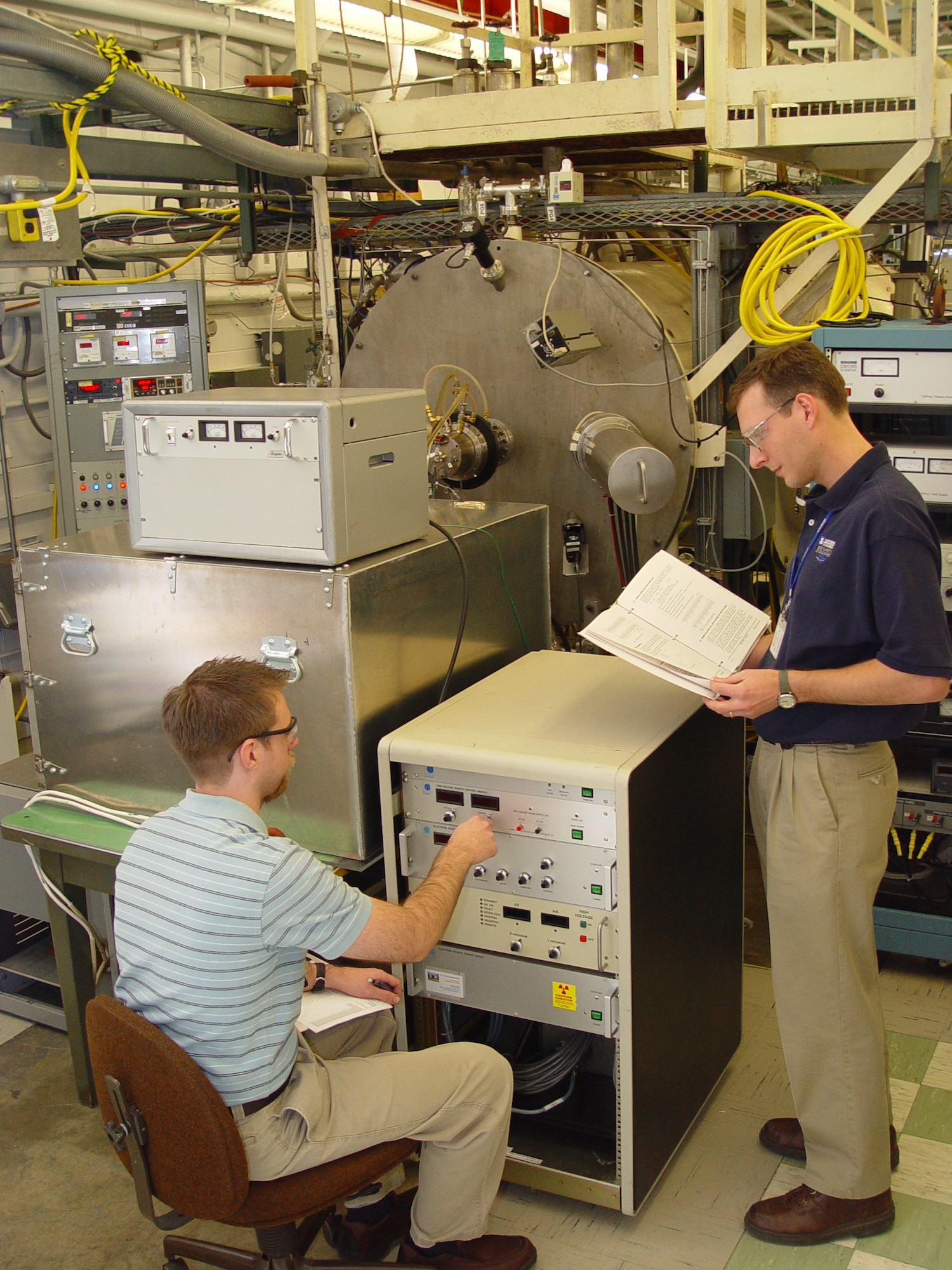 (From left) Dustin Crider, a physicist in ATA’s Technology and Analysis Branch, and ATA Space Chamber Research Lab Project Manager John Prebola adjust the Characterization of Combined Orbital Surface Effects (CCOSE) chamber’s electron source output to match the low earth orbit environment in preparation for a checkout of the newly configured CCOSE chamber. (Photo by Philip Lorenz III)