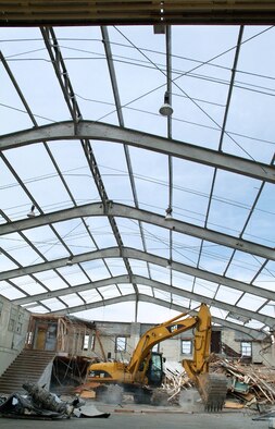 Excavator operator Paul Snell of Contaminant Control, Inc. works on demolition of Building 0228, often called the Old Biloxi Hangar.  Leveling the structure had been planned for some time, but hurricane damage made it a higher priority.  Plans call for constructing the aeromedical port on the site if funding can be secured. (U.S. Air Force photo by Adam Bond)

