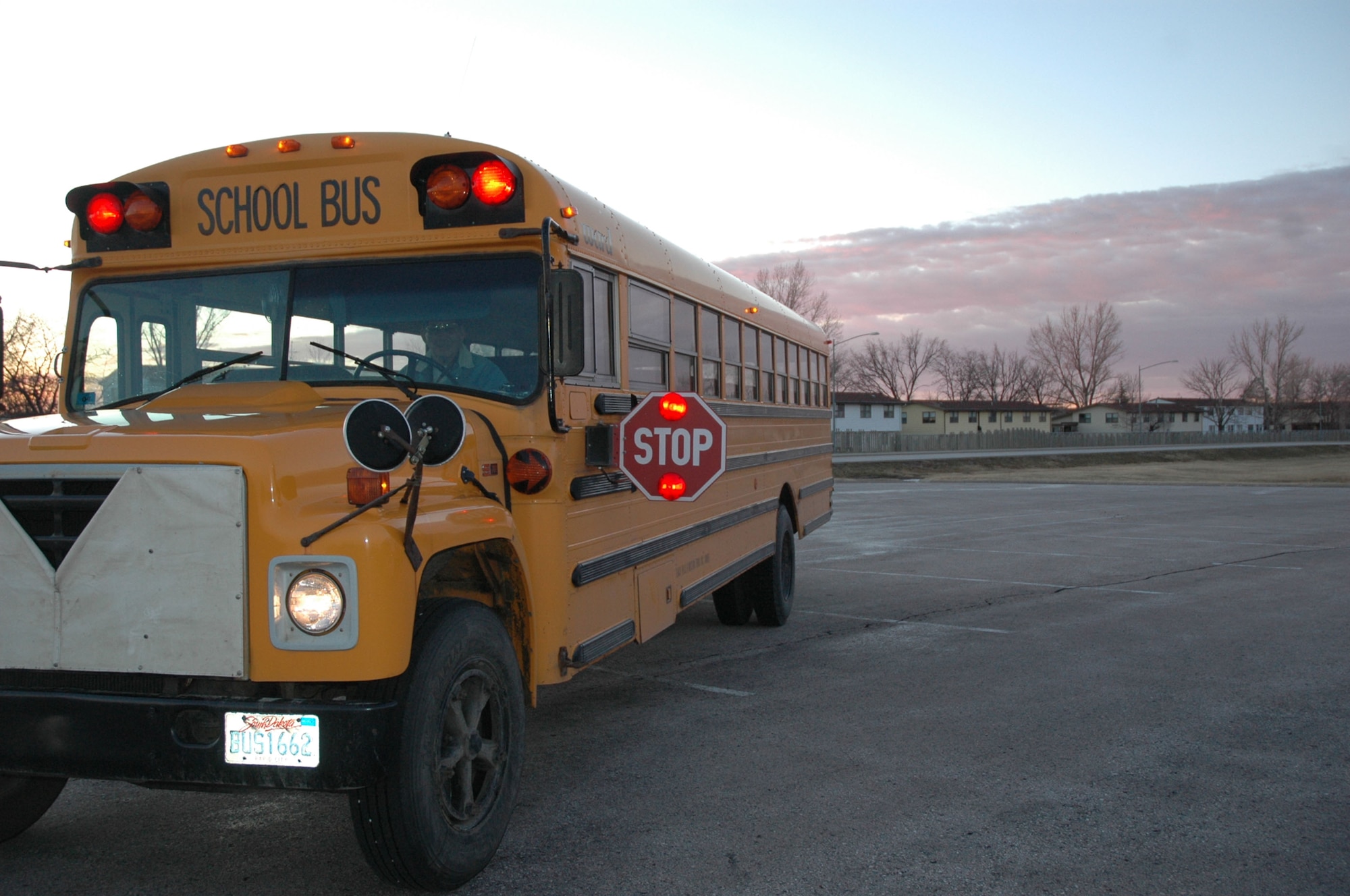 A school bus awaits its precious cargo of children on a brisk Monday morning at Ellsworth. The installation secured last minute funding from Air Combat Command to ensure there was bus service until the end of this school year, but base leadership  stresses the importance of parents formulating a transportation plan for the next school year as there is no further Air Force funding available for school buses. (U.S. Air Force photo/Tech. Sgt. Steven Wilson)