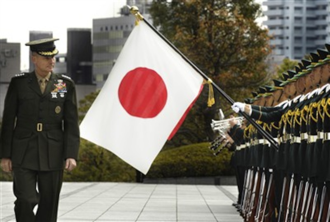 Chairman of the Joint Chiefs of Staff U.S. Marine Gen. Peter Pace executes a pass and review of Japanese soldiers while visiting the Japanese Ministry of Defense in Tokyo, March 21, 2007. 