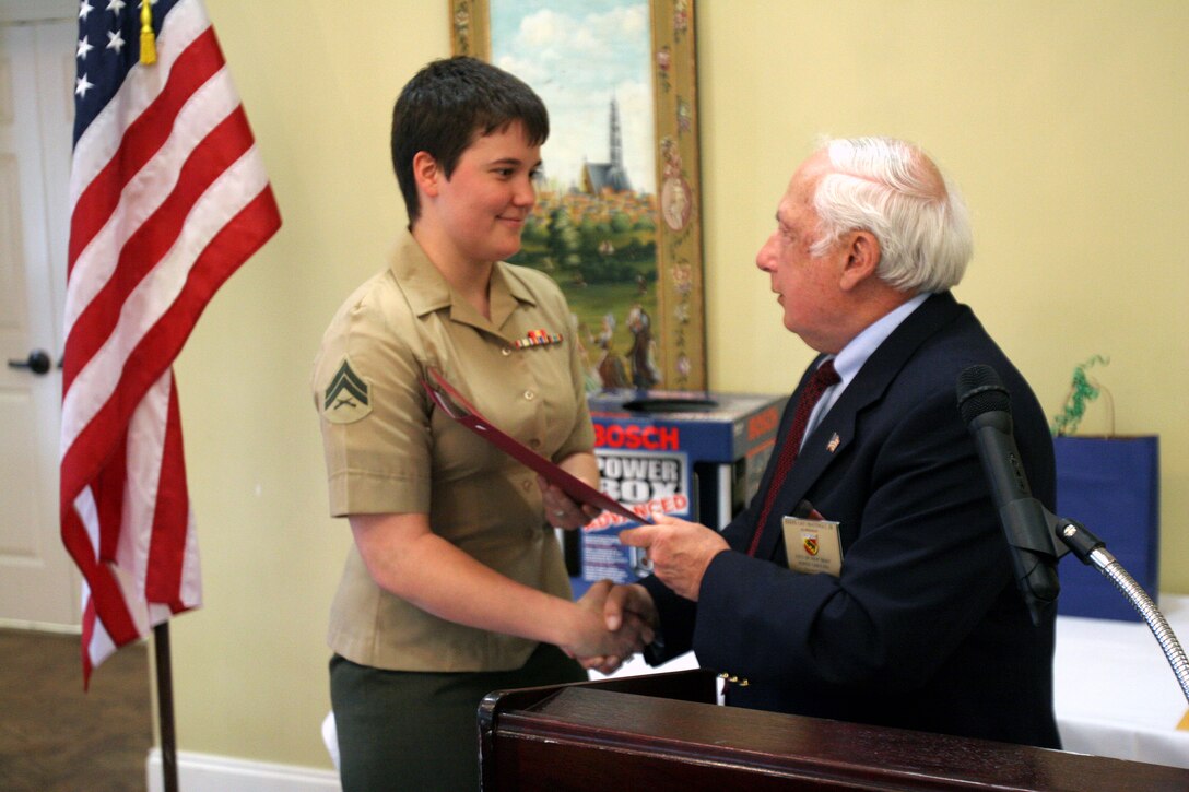 Joseph Mattingly presents a proclamation to Cpl. Samantha Poss from the city of New Bern for her husband, Cpl. Collins March 22.  Cpl. Jason Collins, an electrical equipment repair specialist with Marine Unmanned Aerial Vehicle Squadron 2, was recognized for his superior performance of duty from October to December. Poss is a field radio operator with Unmanned Aerial Vehicle Squadron 2 and Mattingly, an alderman with the New Bern chamber of commerce.