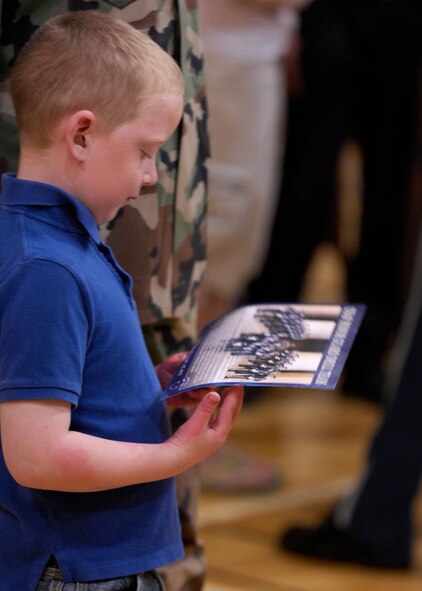 Hunter Horton, son of First Lt. Heath Horton , 377th Mission Support Group, receives autographs from the United States Air Force Honor Guard Drill Team after they perform at the West Fitness Center on Kirtland Air Force Base, N.M., March 15, 2007. The Drill Team is the traveling component of the Air Force Honor Guard and tours Air Force bases world wide showcasing the precision of today's Air Force to recruit, retain, and inspire Airmen for the Air Force mission. (U.S. Air Force photo by Airman 1st Class Rusti Caraker)(Released)
