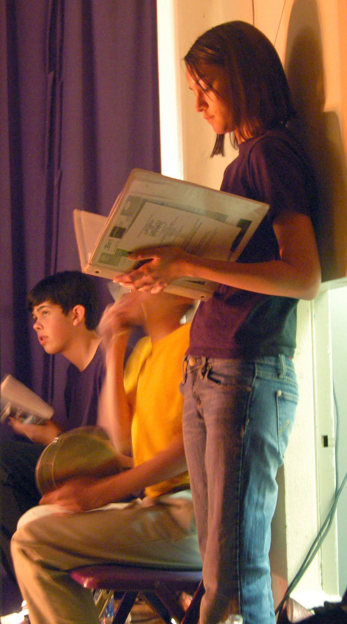 Students read their scripts backstage during the "Little Shop of Horrors" premiere. (Photo by Airman 1st Class Julius Delos Reyes)