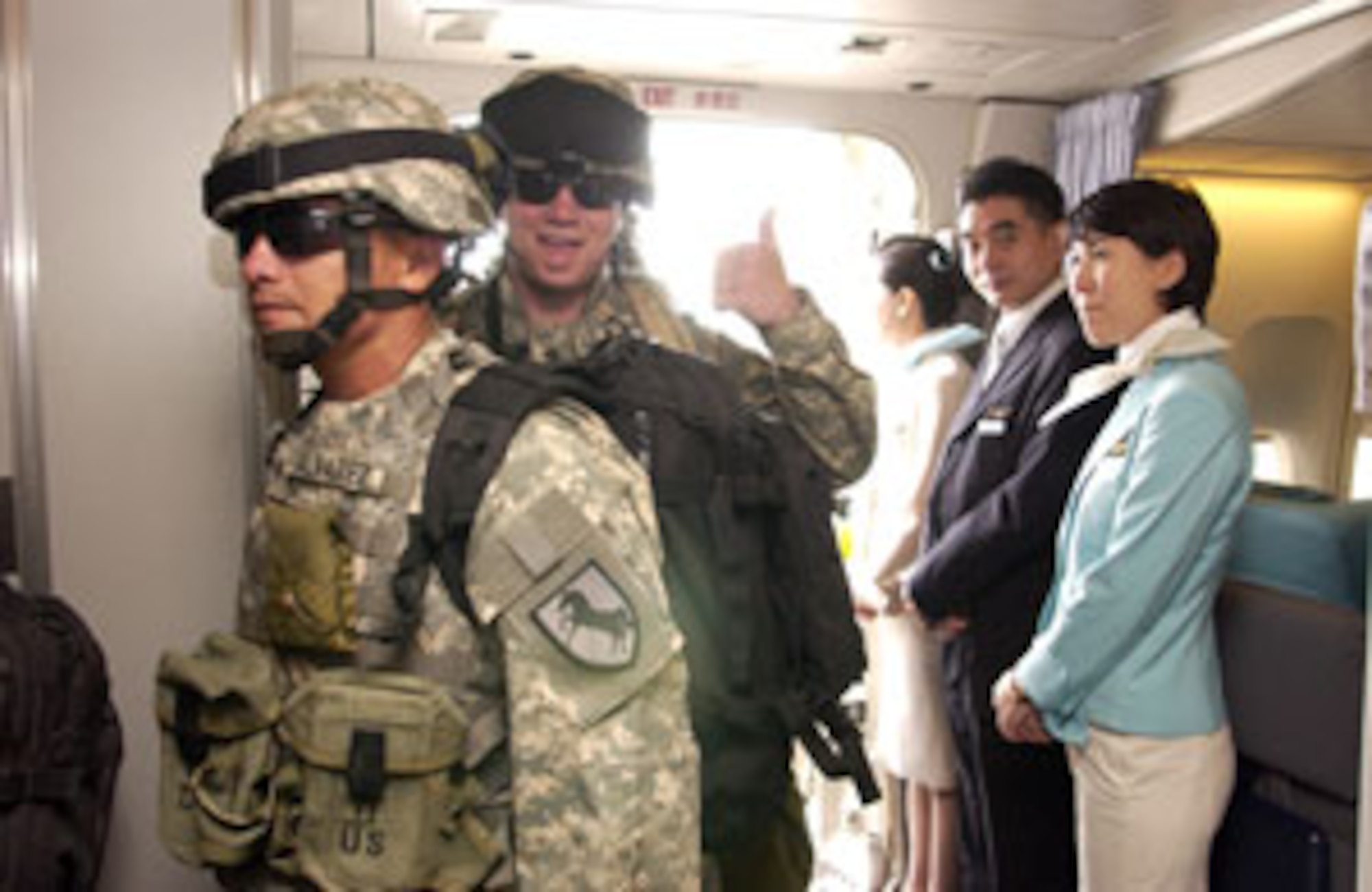 Soldiers from Fort Irwin, Calif., board a Korean Air 747 at March Air Reserve Base, Calif., Wednesday. This marks the first time a Korean airlines aircraft has physically been exercised as part of the 26 year Mutual Airlift Support Agreement between the Department of Defense and the South Korean Air Force.   (U.S. Air Force photo by Staff Sgt. Amy Abbott, 452 AMW/PA)                            