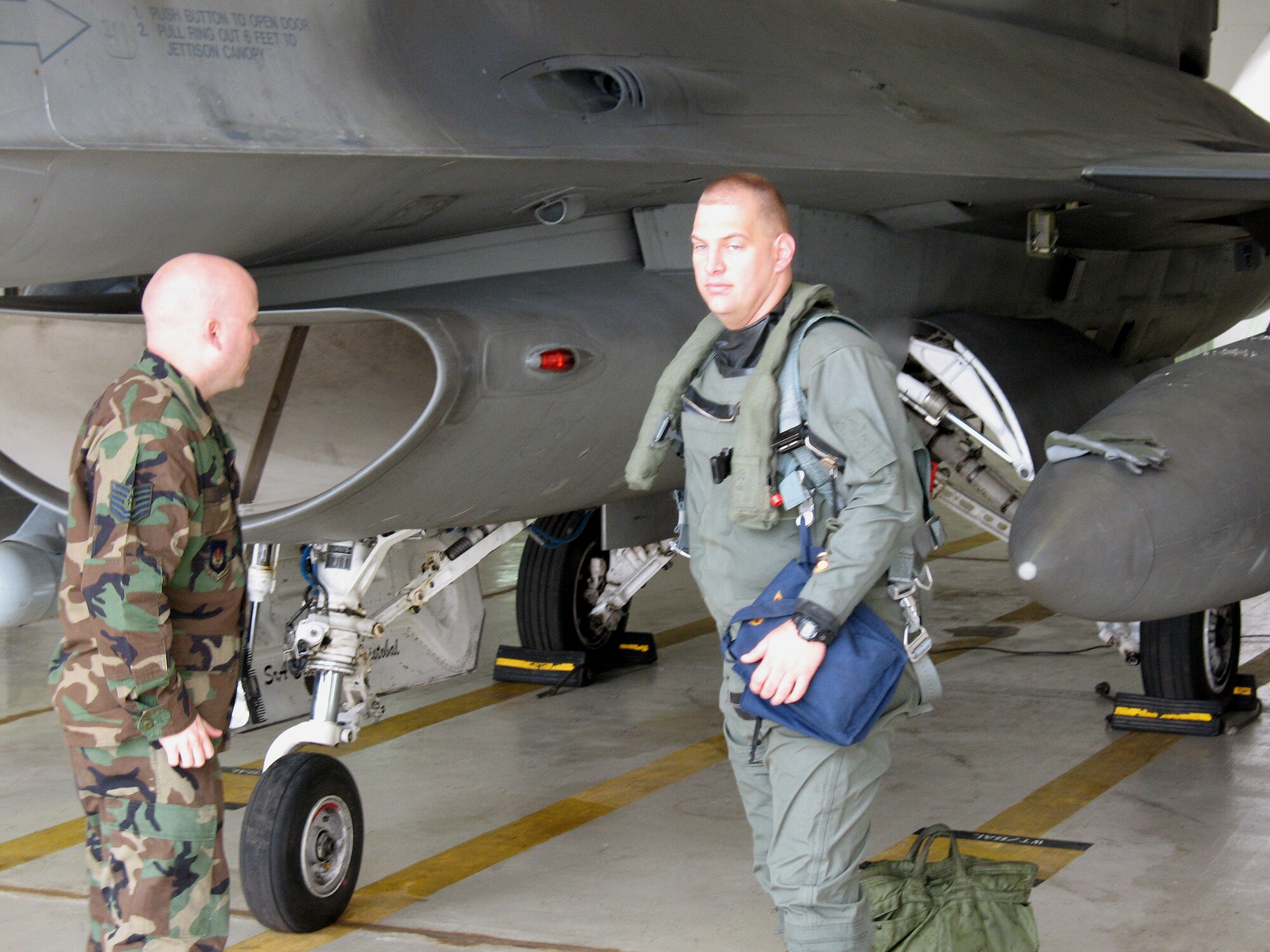Tech. Sgt. Bret Barlow, an F-16 Fighting Falcon crew chief at the 52nd Fighter Wing at Spangdahlem Air Base, Germany, performs pre-flight checks as Maj. James Gump, an F-16 pilot and the weapons and tactics officer for the 39th Operations Squadron at Incirlik Air Base, Turkey, prepares to climb in the aircraft. Major Gump flew the fighter back to its home station at Spangdahlem. (U.S. Air Force photo)